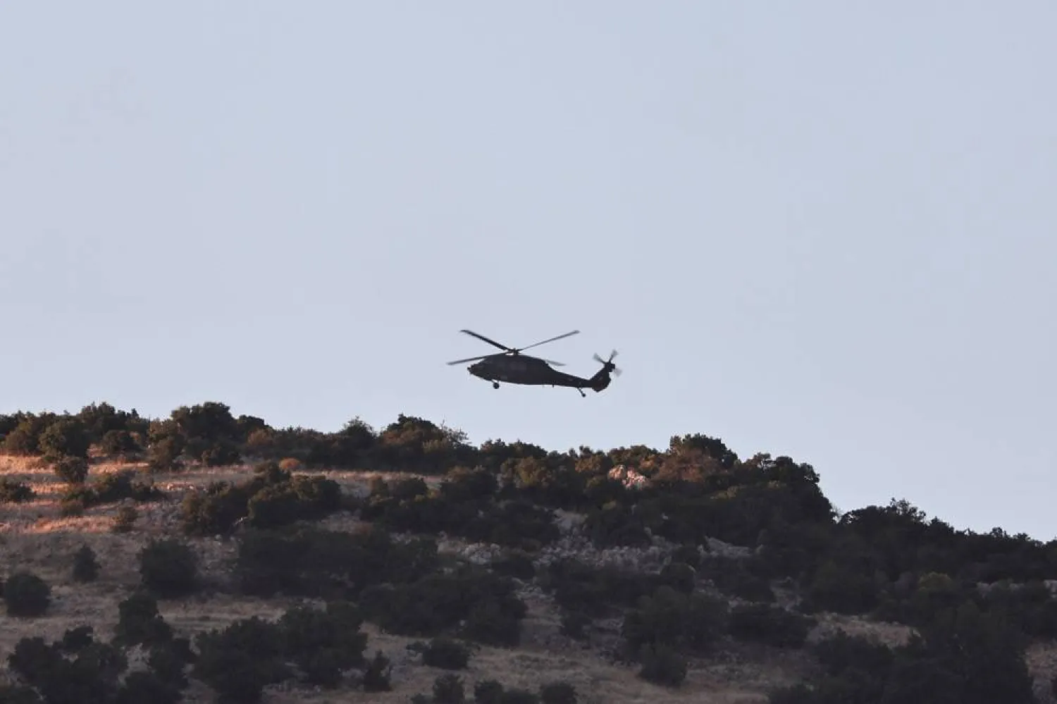 An Israeli helicopter flies on patrol near the Israel-Lebanon border, 23 June 2026, amid a ceasefire between Israel and Hezbollah. (EPA)
