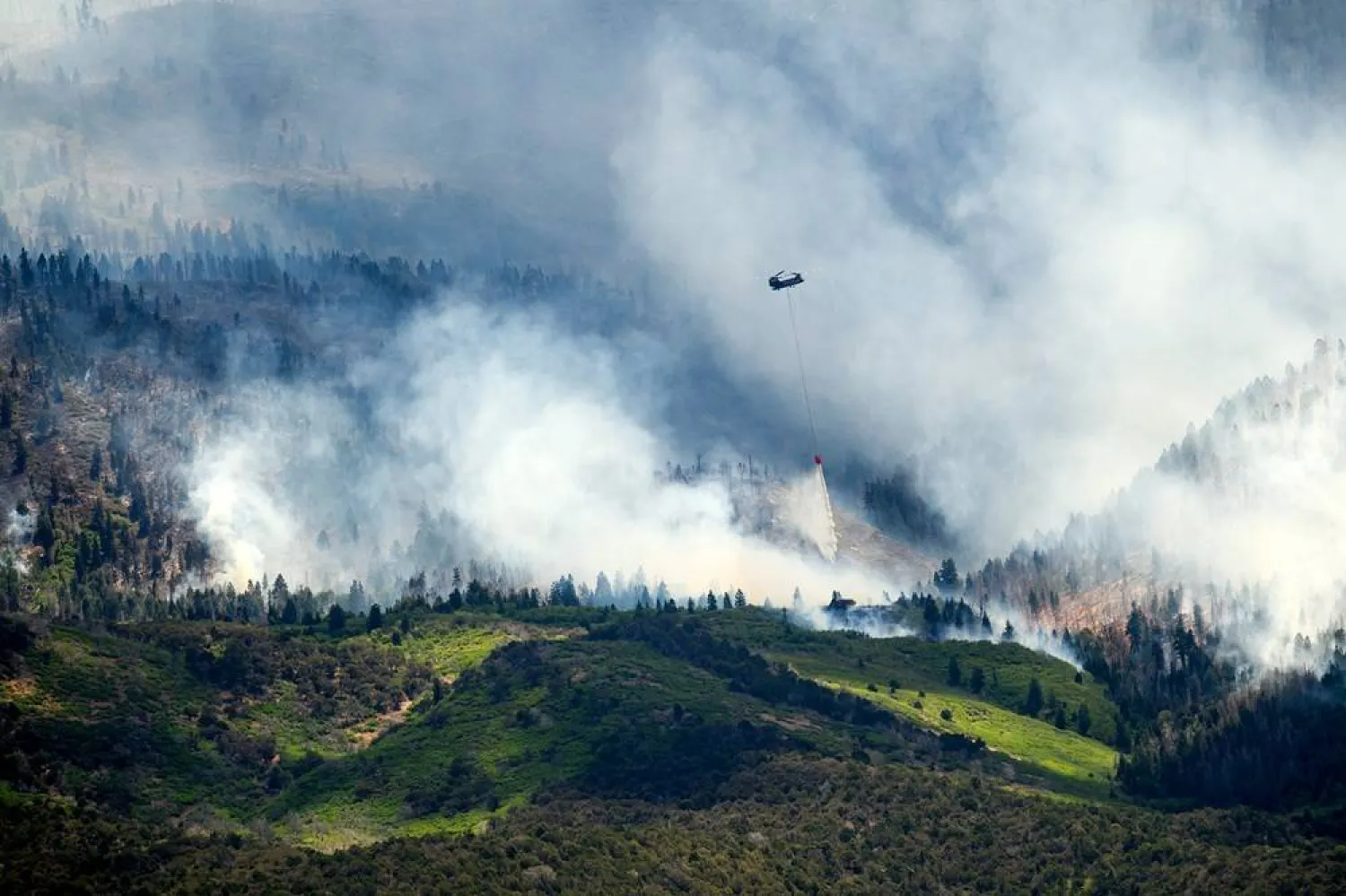 A helicopter drops water on the Cottonwood Fire burning near Beaver, Utah, on Saturday, June 27, 2026. (AP)