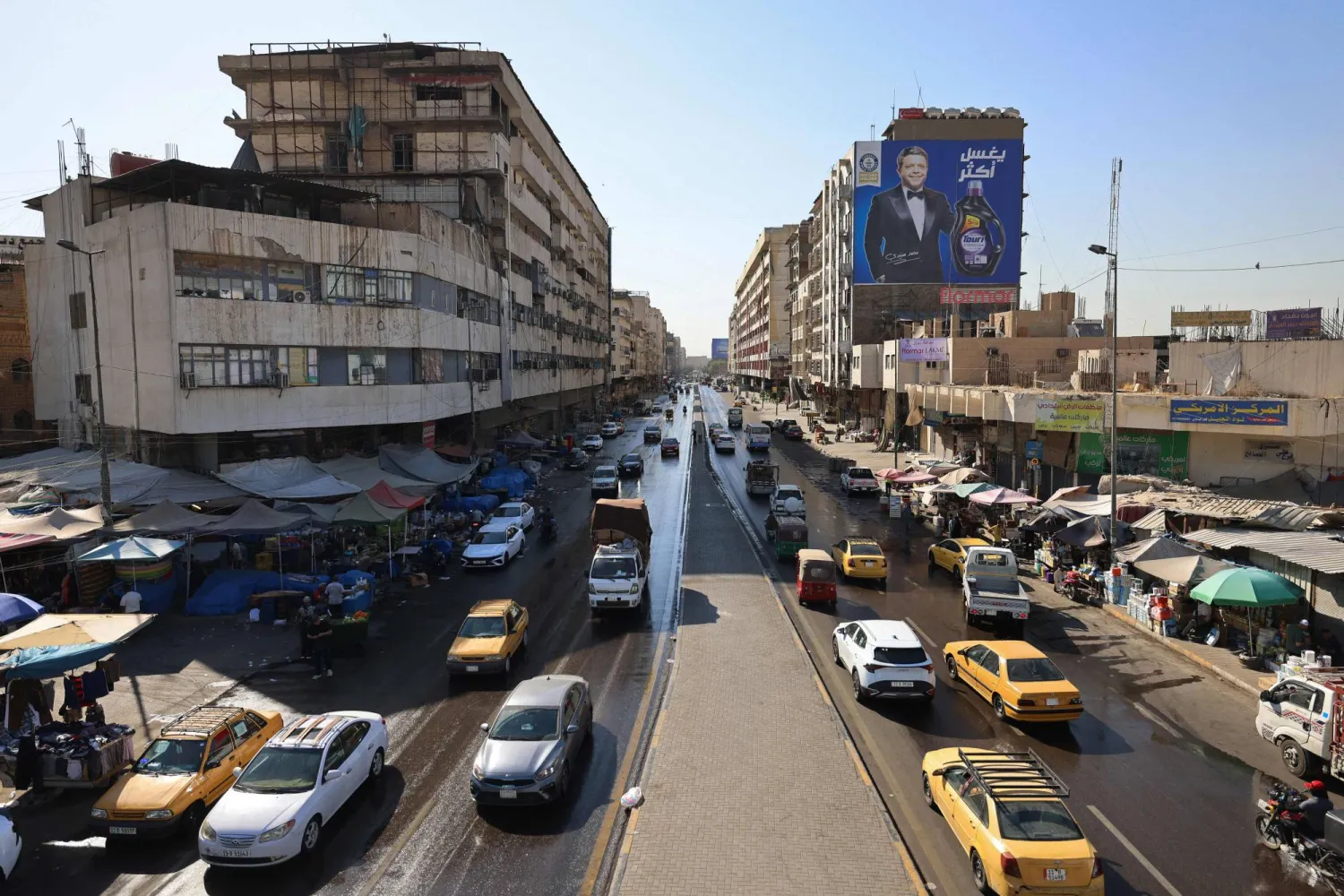  Vehicles drive along the Al-Jumhuri street in central Baghdad on June 28, 2026. (AFP)