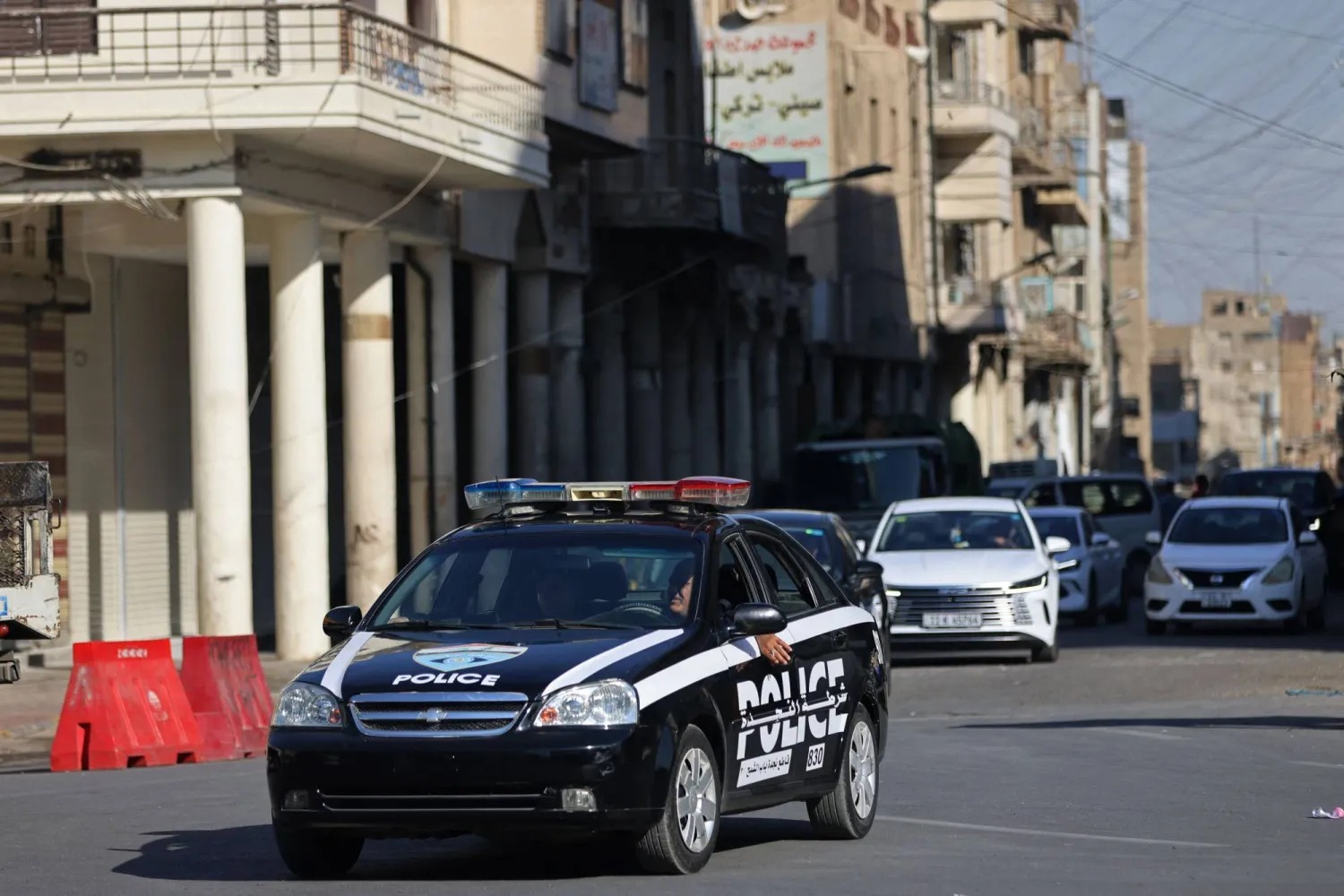 Iraqi police personnel patrol in their vehicle along a street in Baghdad on June 28, 2026. (AFP)