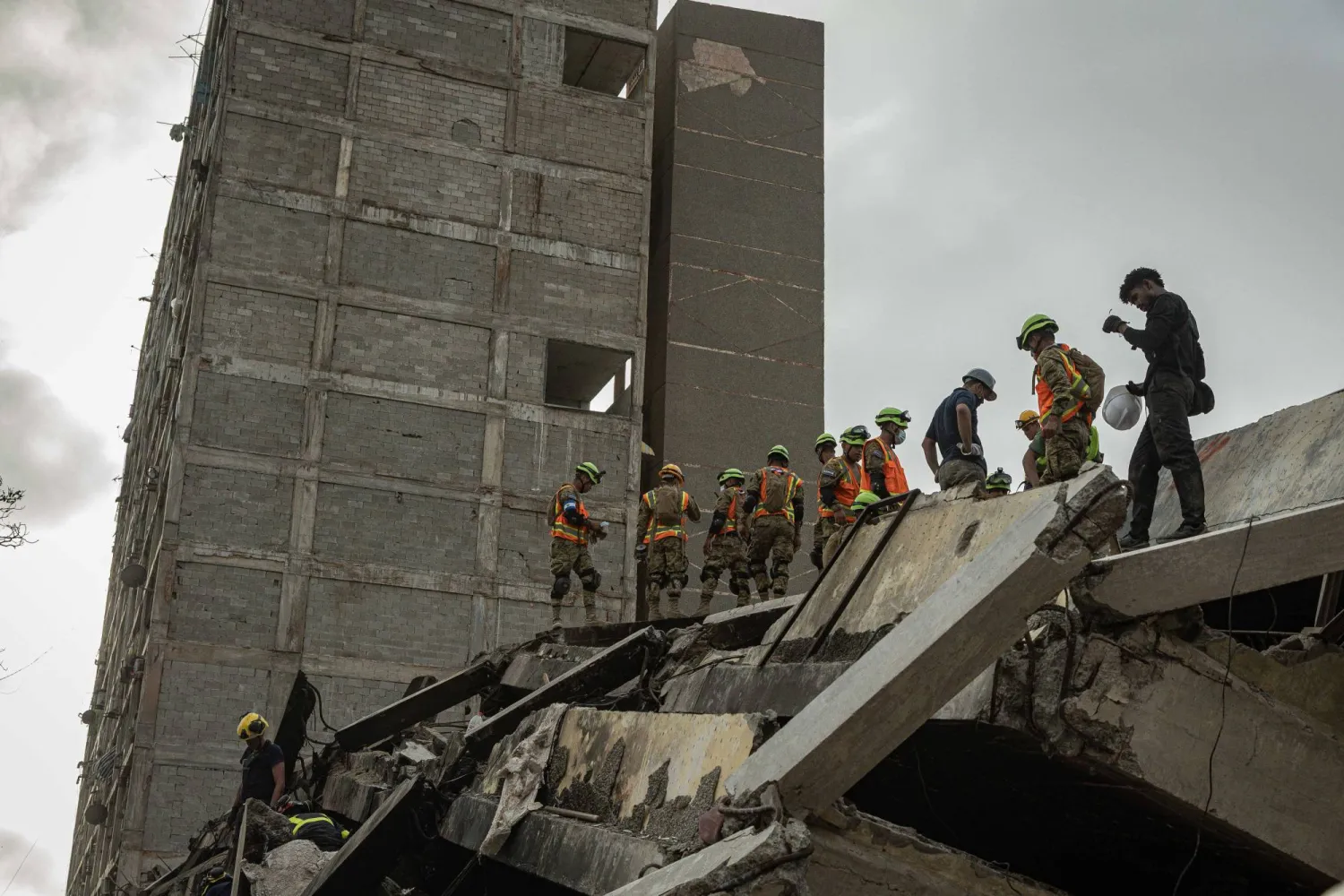 Rescue workers search for survivors among the rubble following two earthquakes with magnitudes of 7.2 and 7.5 in Catia La Mar, La Guaira state, Venezuela, 29 June 2026. EPA/Henry Chirinos
