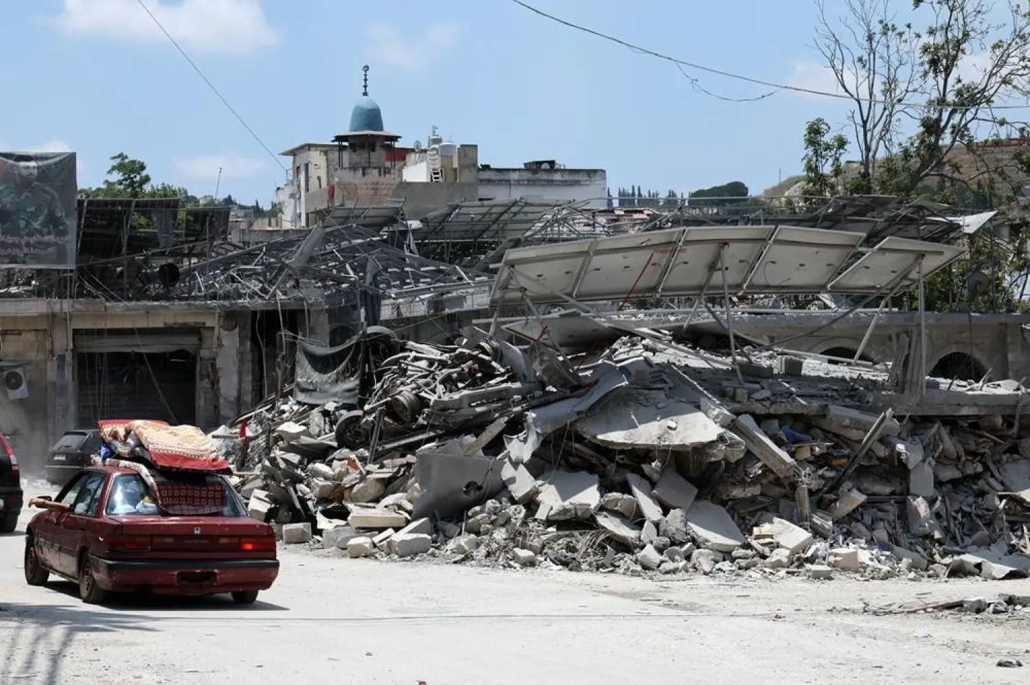 Lebanese people drive a vehicle loaded with mattresses as they return to their village in the town of Nabatieh, southern Lebanon, 23 June 2026, amid a ceasefire between Israel and Hezbollah. (EPA)