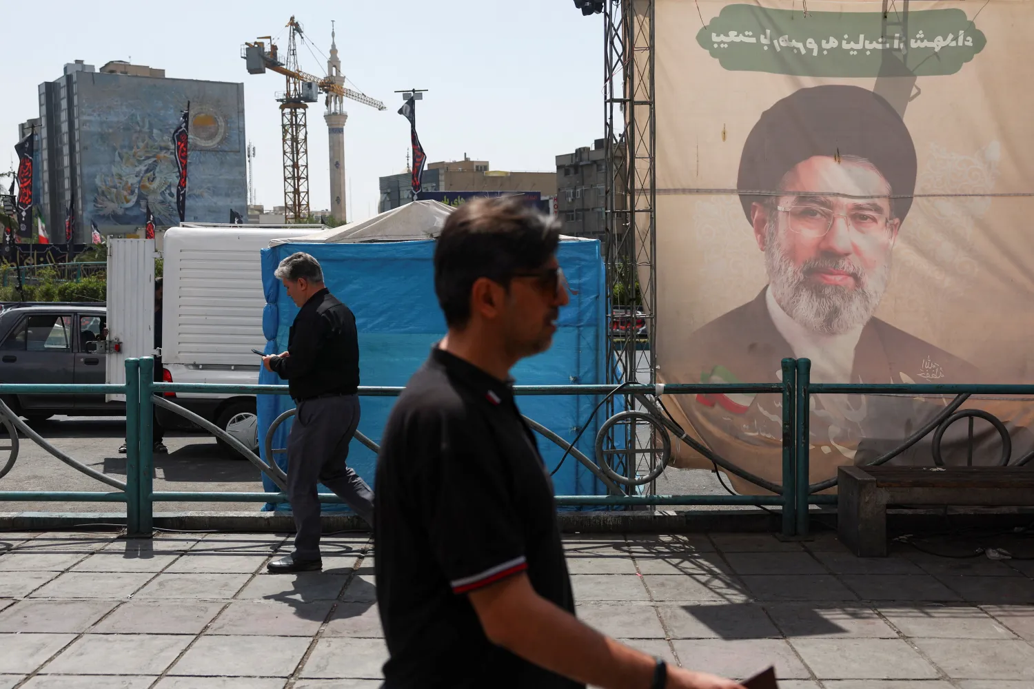 People walk past a banner with a picture of Iran's Supreme Leader, Mojtaba Khamenei, in Tehran, Iran, June 17, 2026. Majid Asgaripour/WANA (West Asia News Agency) via REUTERS