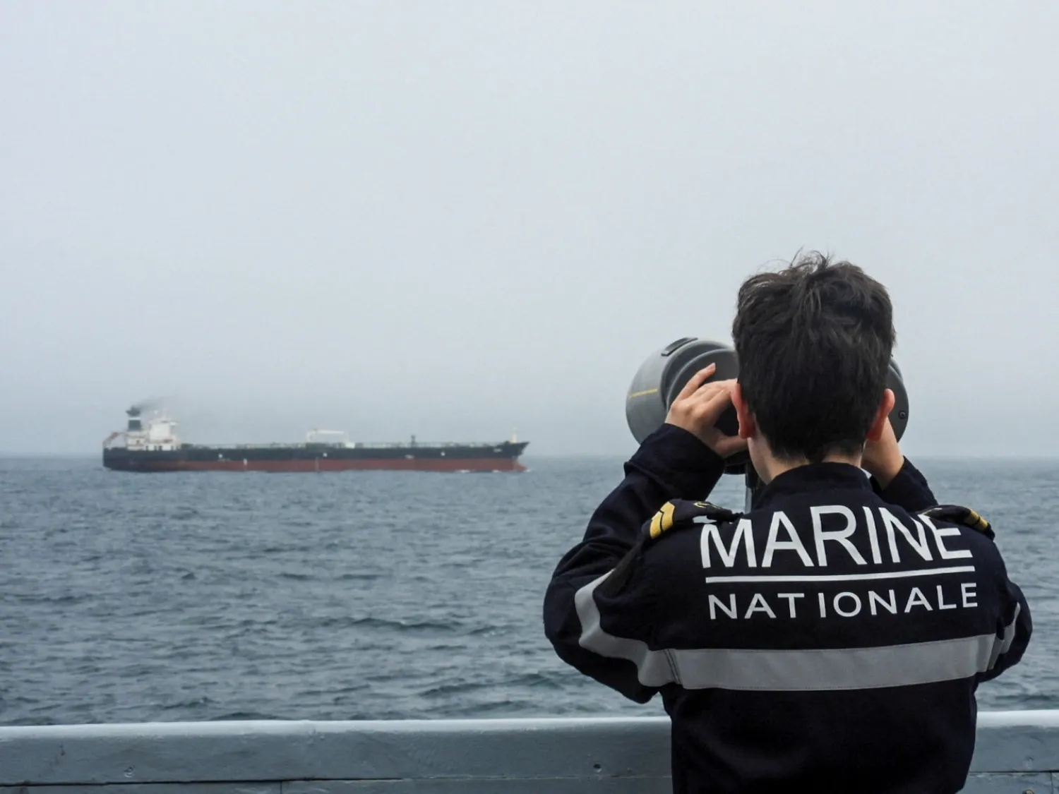 A French Navy personnel observes an oil tanker, subject to international sanctions and sailing from Russia, sailing in the Atlantic Ocean, in this handout obtained by Reuters on June 1, 2026. (Marine Nationale/Handout via Reuters) 