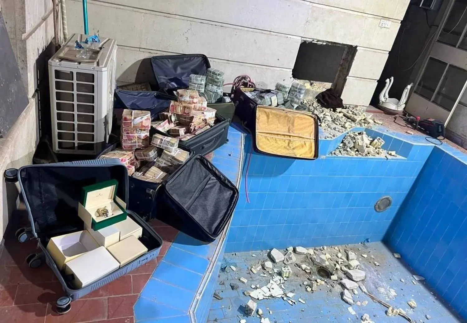 A photo released by Iraq’s judiciary shows cash and valuables that were hidden in the home of Deputy Oil Minister Ali Maarij al-Bahadly. 