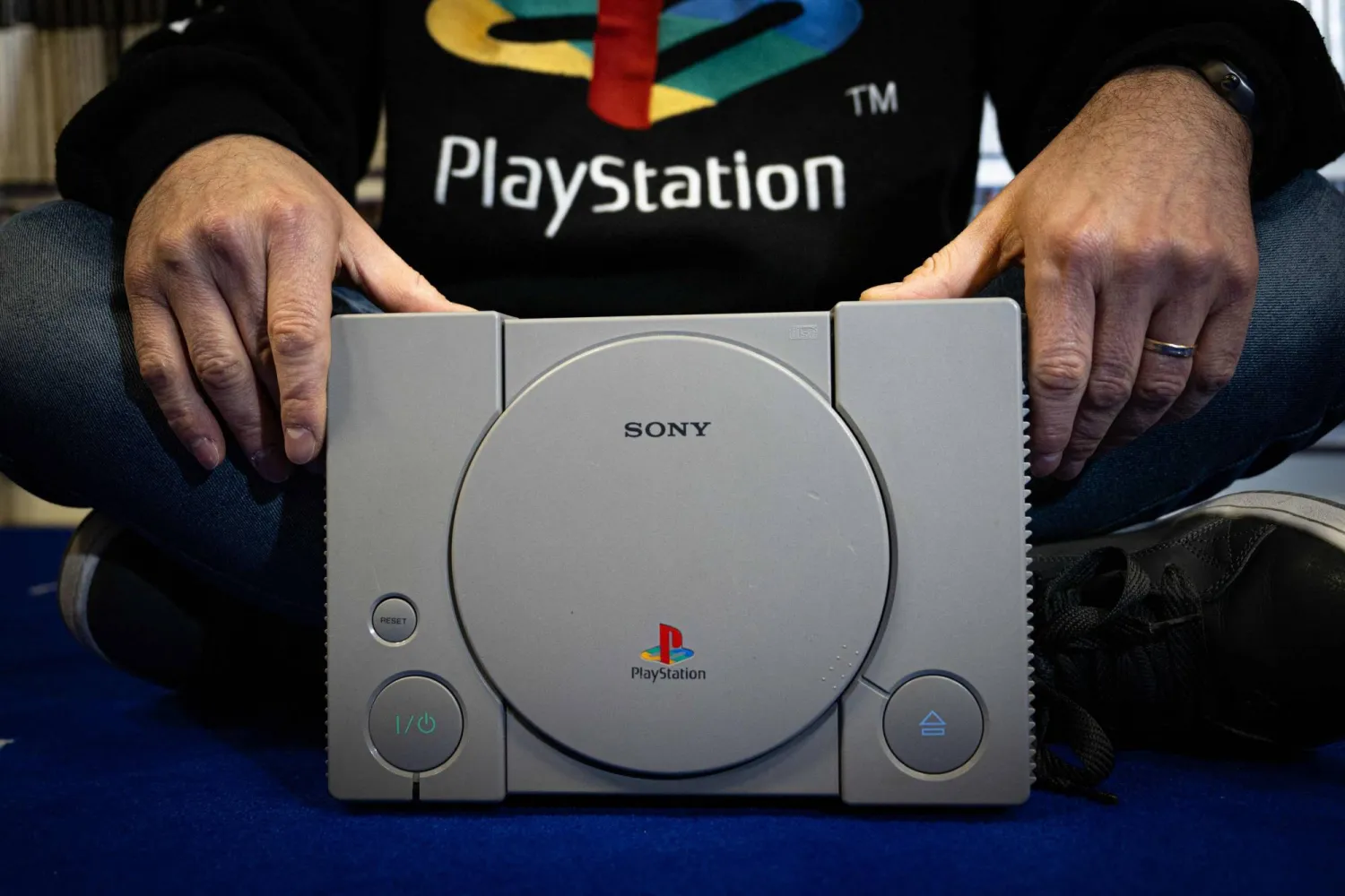 French PlayStation' collector Cyril, poses with a PlayStaion 1, at his home in Vraiville, on November 20, 2024. (AFP)