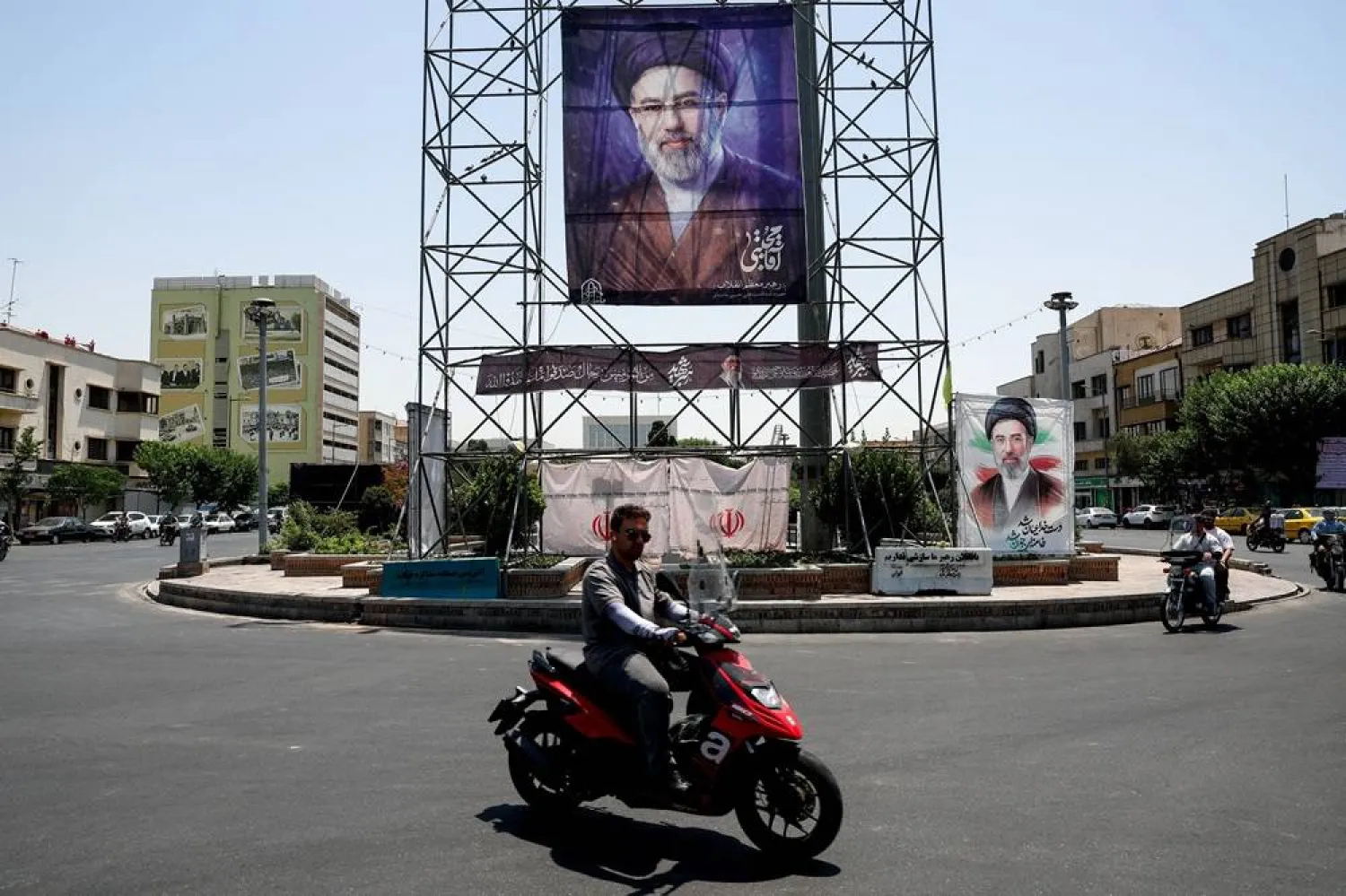 People ride past a banner with a picture of Iran's Supreme Leader, Mojtaba Khamenei, in Tehran, Iran, June 28, 2026. Majid Asgaripour/WANA (West Asia News Agency) via Reuters