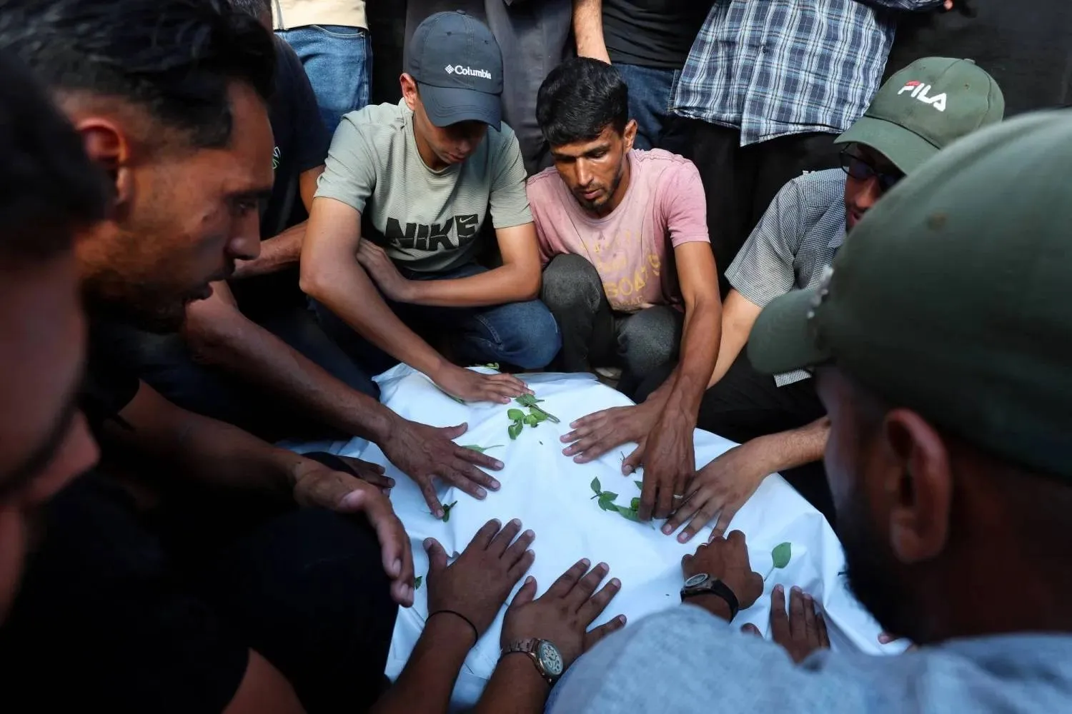 Mourners attend the funeral of three Palestinians who were killed in an Israeli strike in Khan Younis in the southern Gaza Strip on Wednesday. (Reuters) 