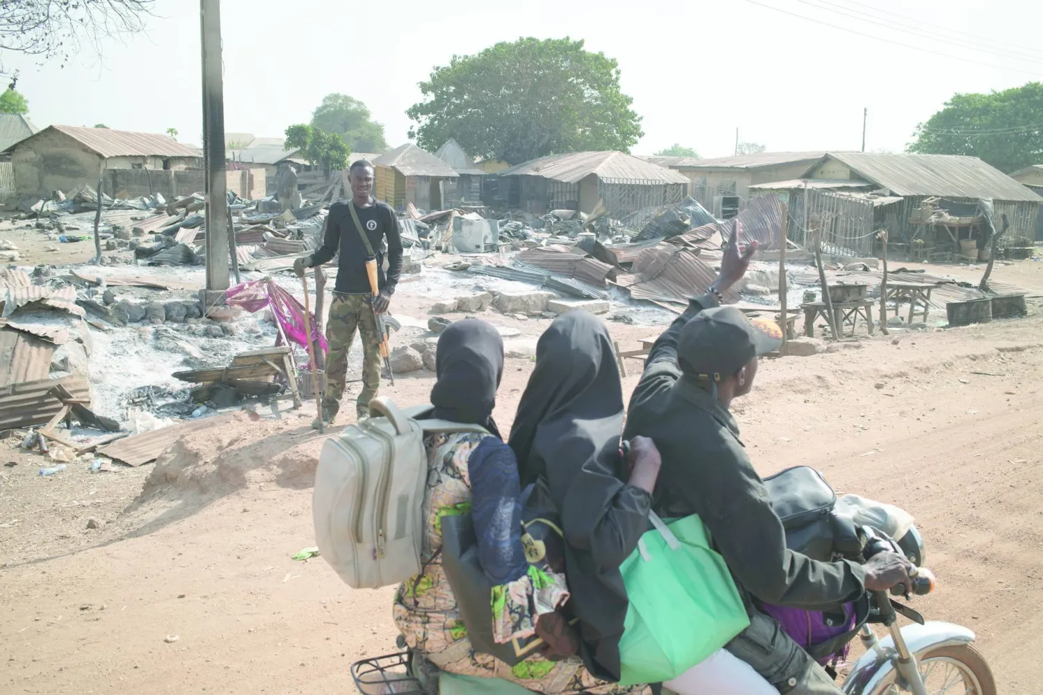 A soldier patrols outside burned homes, days after an attack in the village of Woro, Nigeria, Thursday, Feb. 5, 2026. (AP Photo/Pelumi Salako)