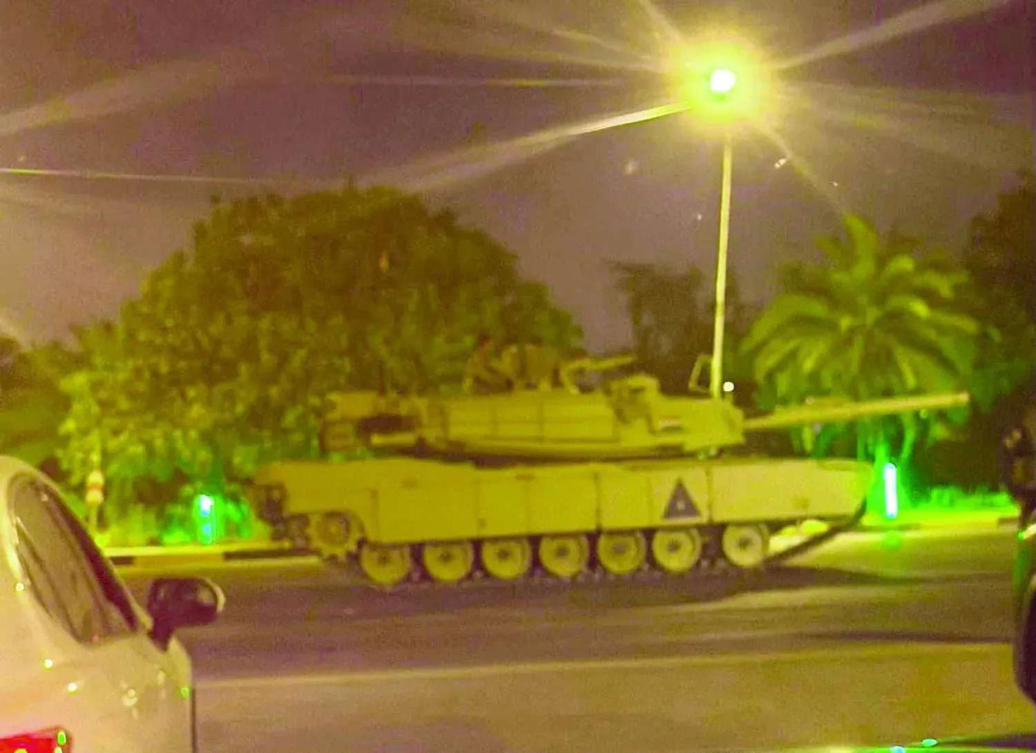 Aktivistler tarafından kaydedilen bir videodan alınan ekran görüntüsünde, yolsuzluk suçlamalarıyla tutuklanan yetkililerin gözaltına alınmasıyla eş zamanlı olarak Yeşil Bölge içinde bir Irak tankı görülüyor.