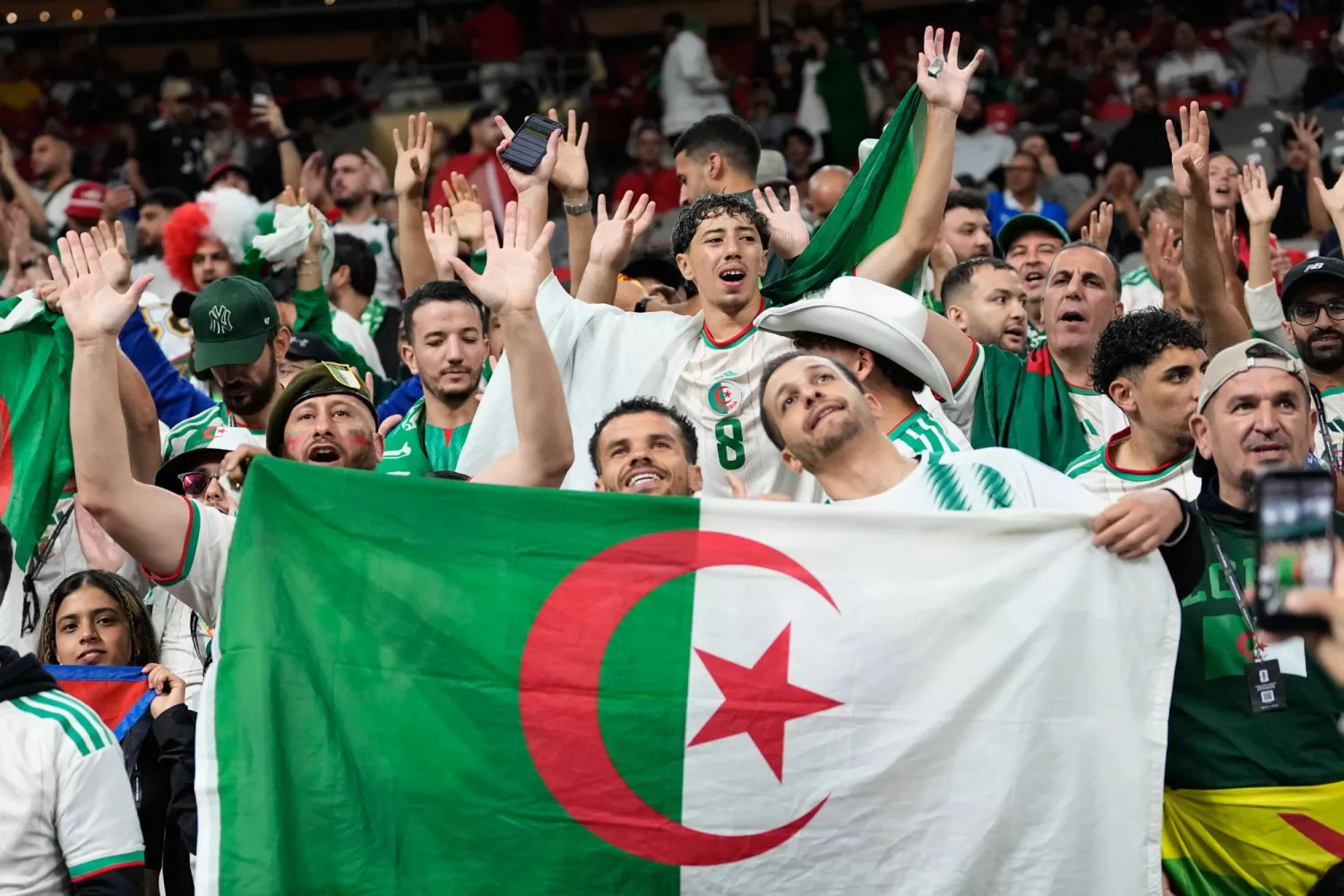مشجعون جزائريون يتفاعلون قبيل المباراة في فانكوفر (أ.ب) 
