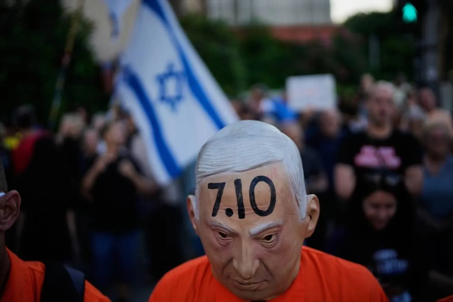 A demonstrator wears a mask depicting Israeli Prime Minister Benjamin Netanyahu during a rally marking 1,000 days to the deadly Oct. 7, 2023, (AP)