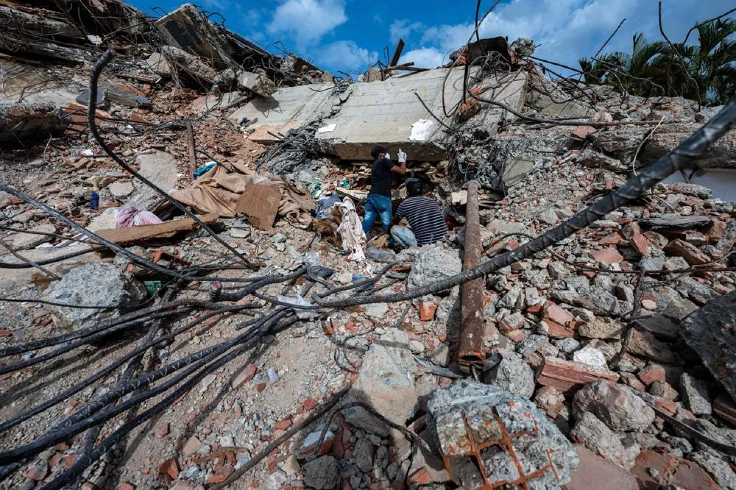 This photograph taken on July 2, 2026 in Caraballeda in the state of La Guaira shows volunteers looking for survivors in a collapsed building following the June 24 twin earthquakes. (AFP)