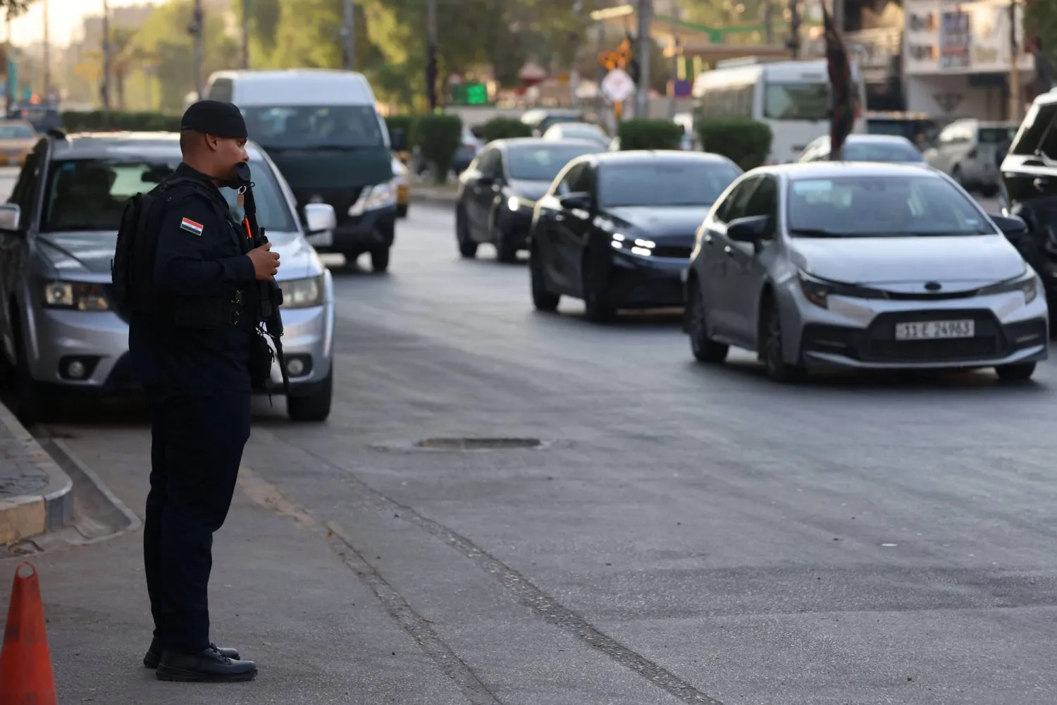 An Iraqi security personnel stands guard along a street in Baghdad on June 28, 2026. (AFP)