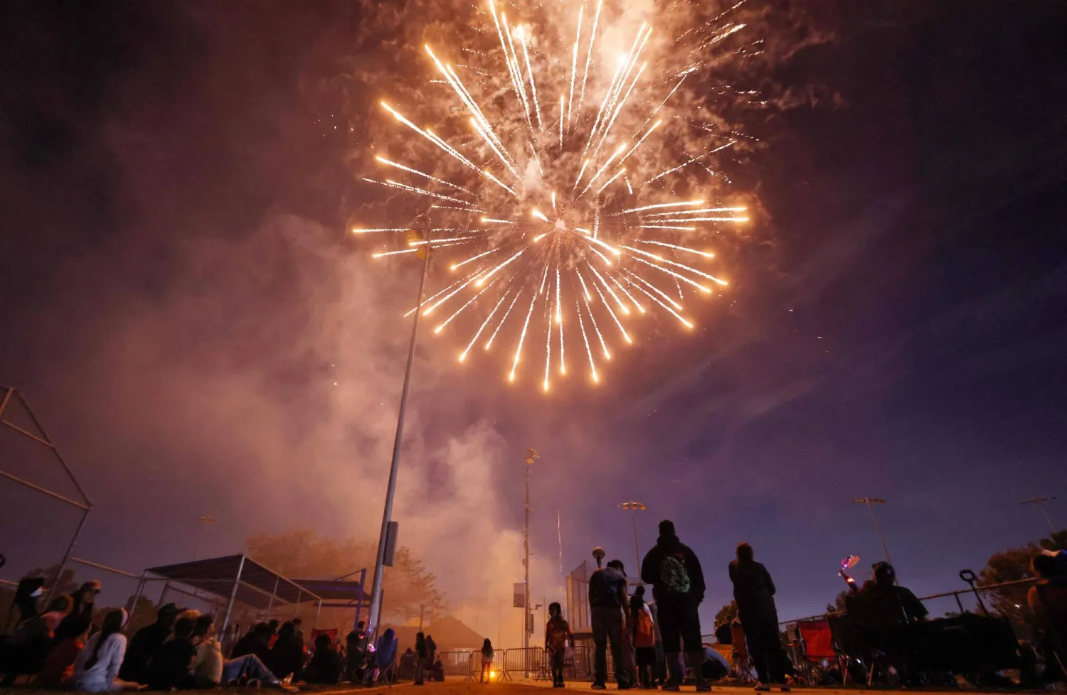 LYNWOOD, CALIFORNIA - JULY 03: People watch fireworks explode during the annual Independence Day Celebration in the predominantly Latino community of Lynwood on July 3, 2026 in Lynwood, California. Mario Tama/Getty Images/AFP