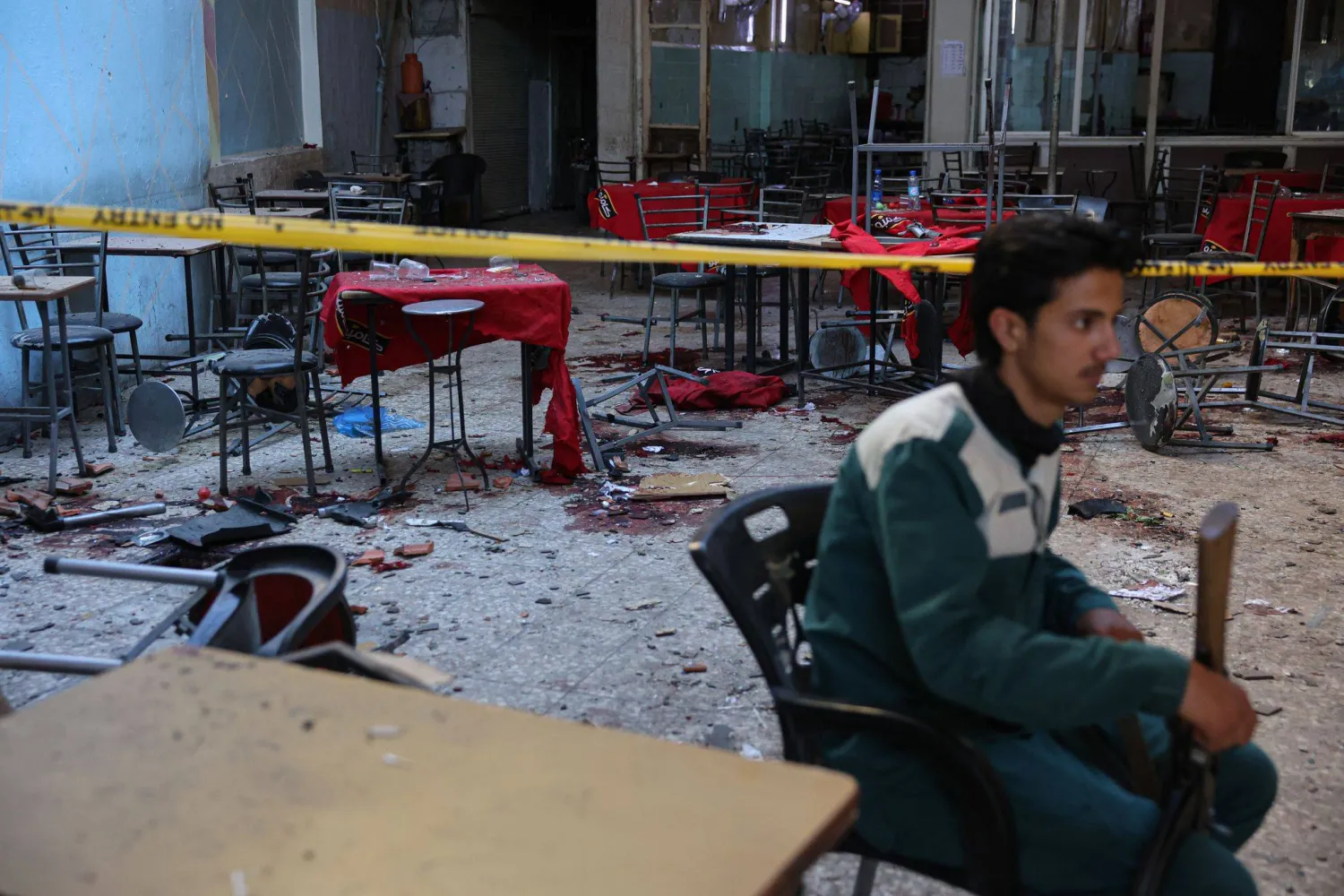 02 July 2026, Syria, Damascus: A member of the Syrian security sits in a cafe after an explosion near the Palace of Justice. Photo: Mohammed Al Rifai/dpa