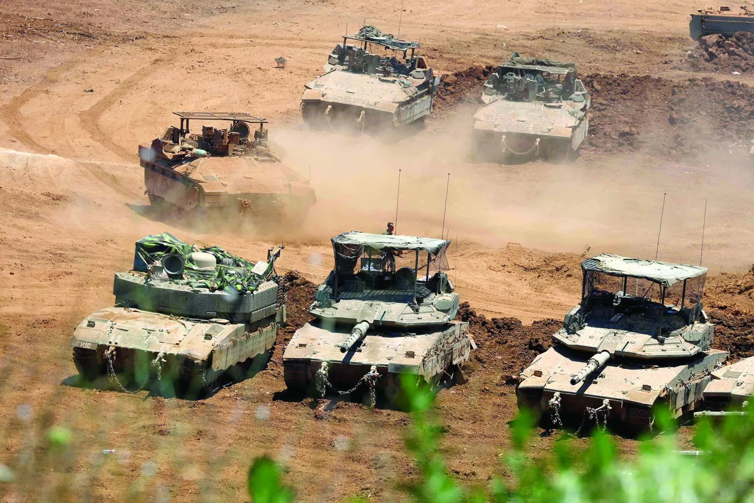 This picture taken from a position in the Upper Galilee in northern Israel shows Israeli army tanks positioned along the Israel-Lebanon border, on July 1, 2026. (Photo by Jack GUEZ / AFP) / 
