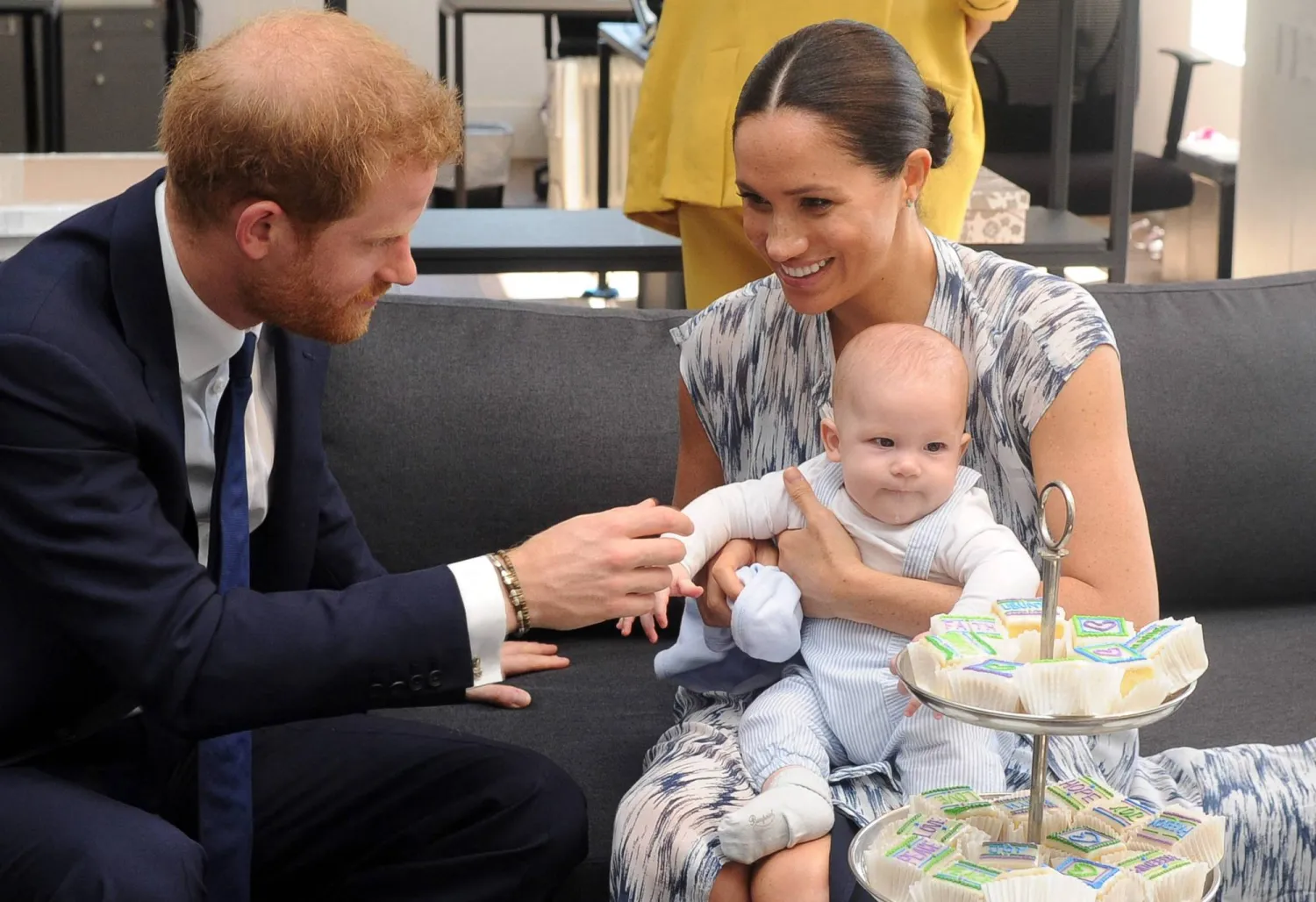 (FILES) Britain's Duke and Duchess of Sussex, Prince Harry and his wife Meghan hold their baby son Archie as they meet with Archbishop Desmond Tutu (unseen) at the Tutu Legacy Foundation in Cape Town on September 25, 2019. (Photo by HENK KRUGER / POOL / AFP)