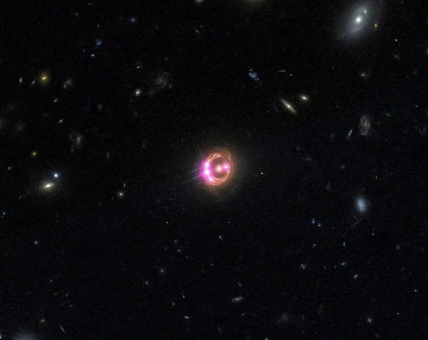 Multiple images of a distant quasar are visible in this undated combined view from NASA’s Chandra X-ray Observatory and the Hubble Space Telescope. (Reuters/NASA handout via Reuters)