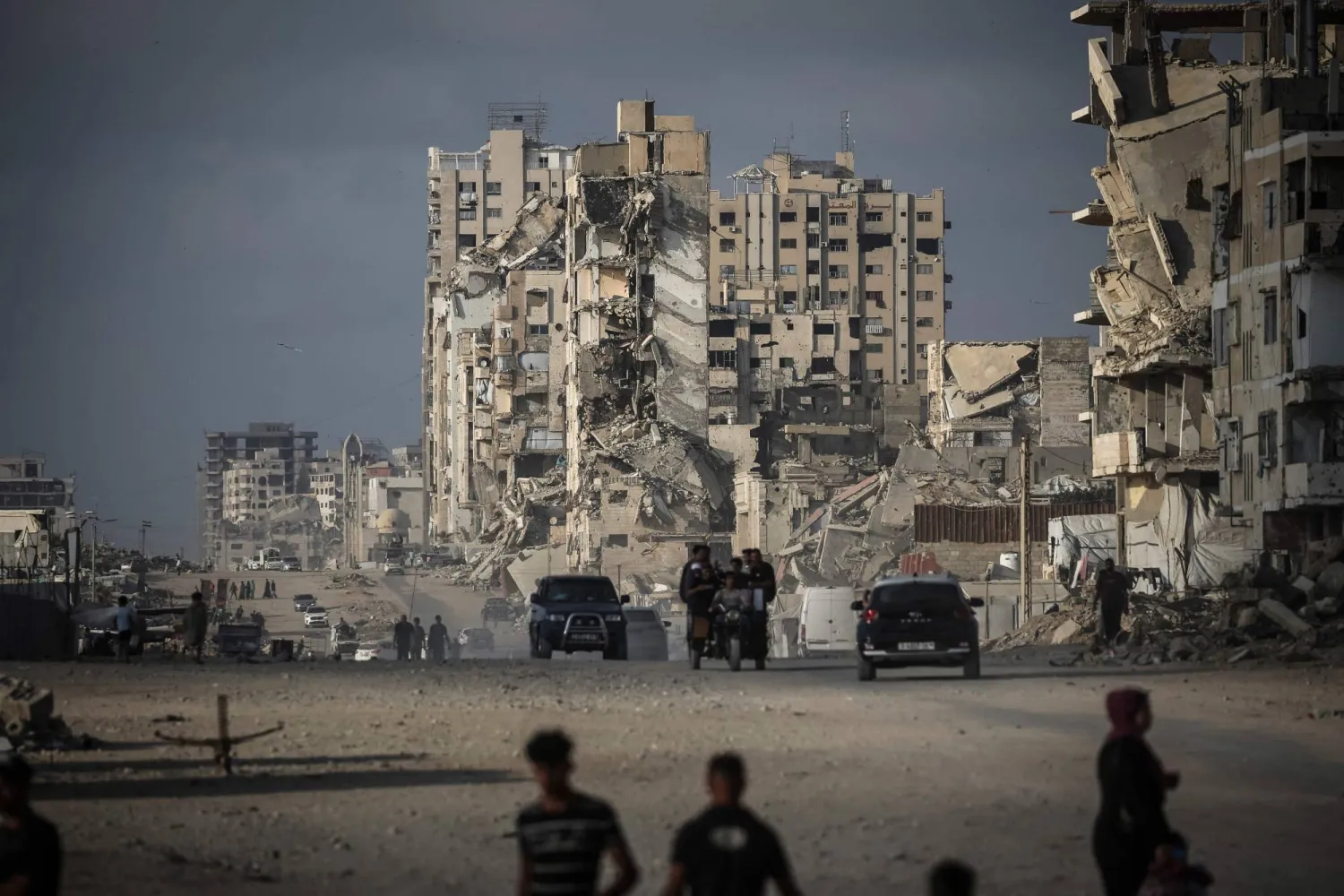 Palestinians walk along a road in Gaza City on July 3, 2026. (AFP)