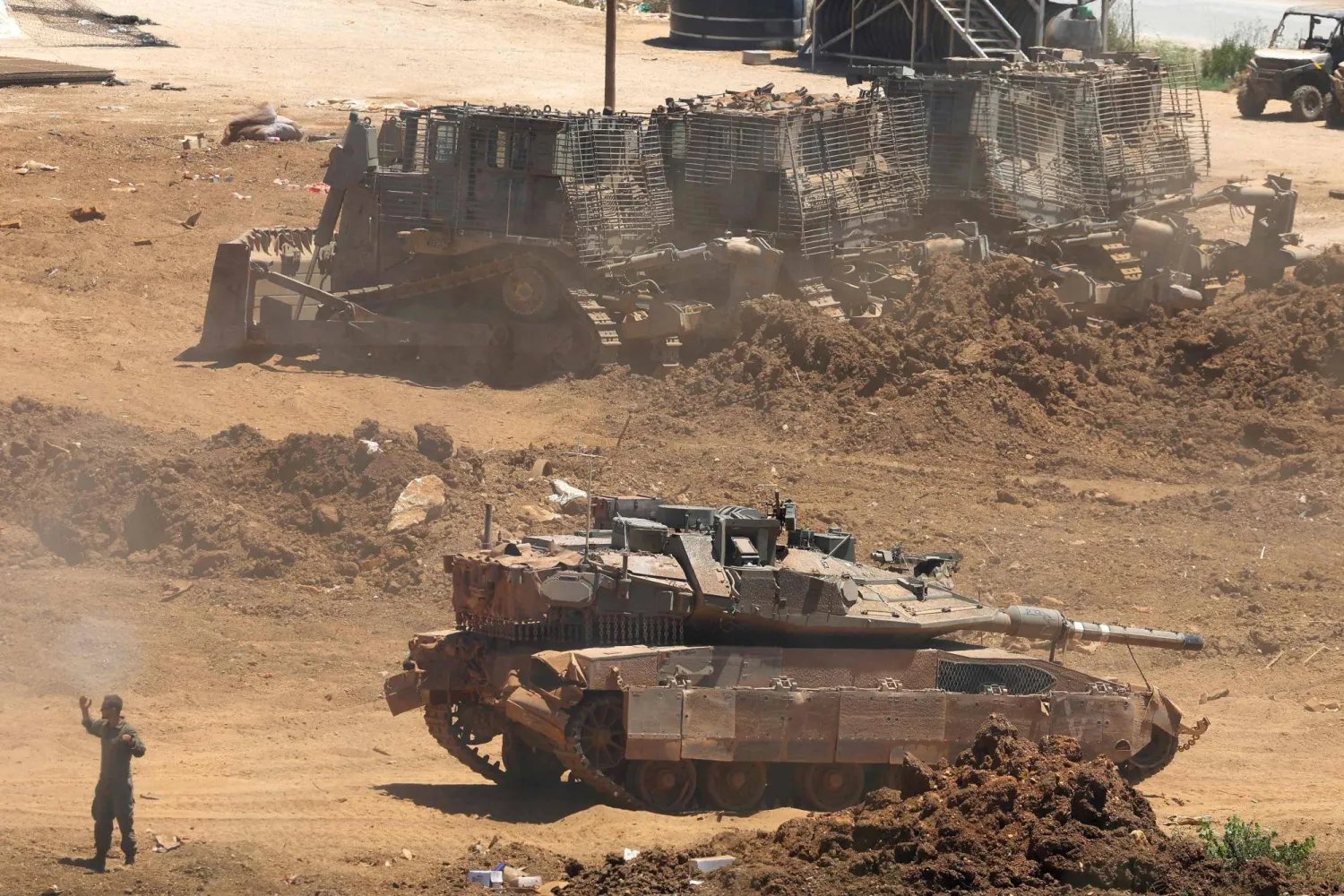 This picture taken from a position in the Upper Galilee in northern Israel shows an Israeli army tank being positioned along the Israel-Lebanon border, on July 1, 2026. (Photo by Jack GUEZ / AFP) 