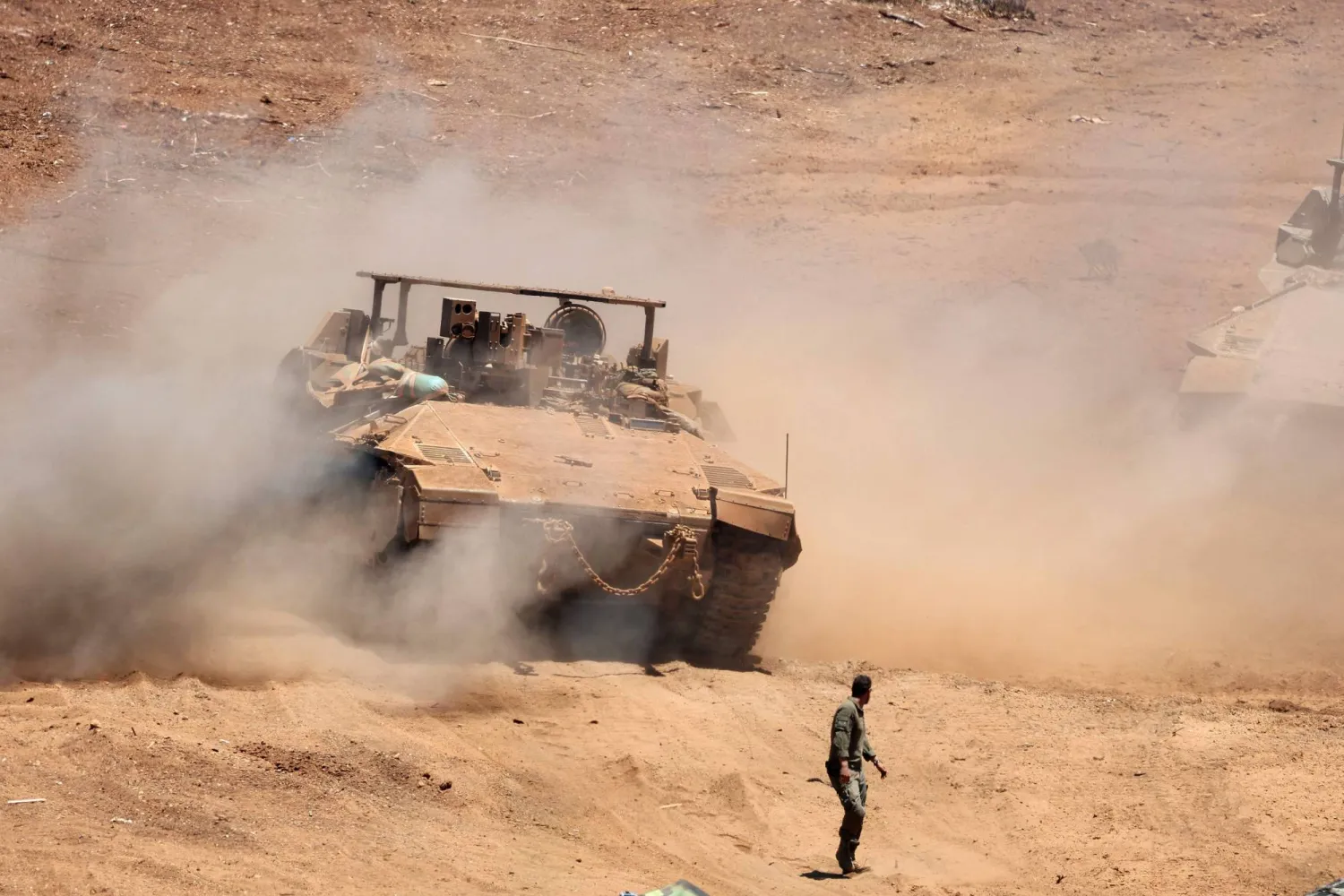 This picture taken from a position in the Upper Galilee in northern Israel shows an Israeli army tank being positioned along the Israel-Lebanon border, on July 1, 2026. (Photo by Jack GUEZ / AFP) / 