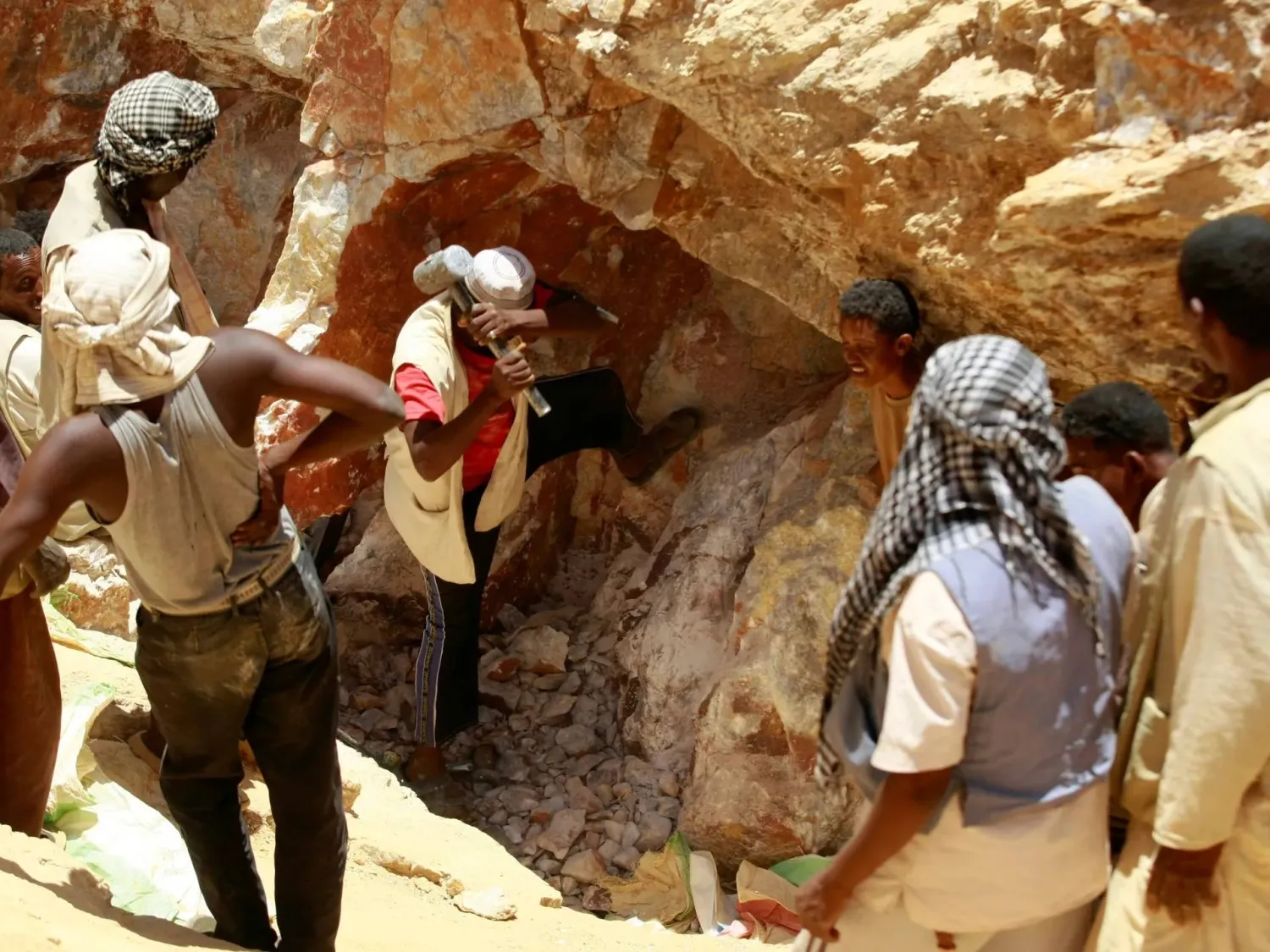 Workers break rocks at a gold mine near Abu Delelq in Gadarif State, Sudan. (Reuters)