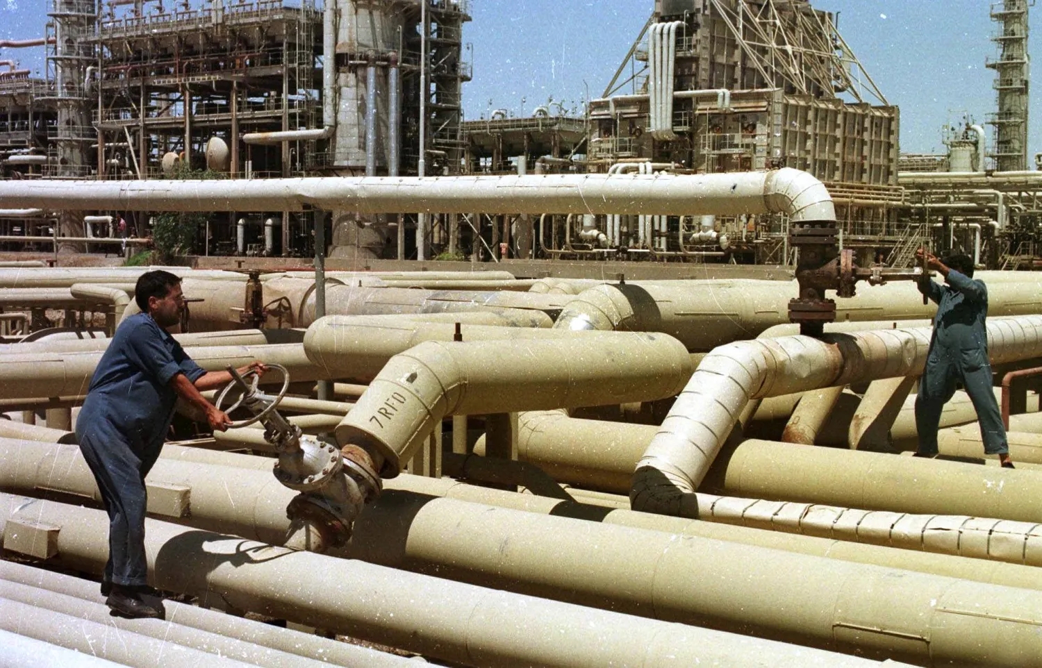 FILE - Iraqi oil workers at an oil installation at Beiji in northern Iraq Tuesday, February 29, 2000. (AP Photo/Jassim Mohammed, File)