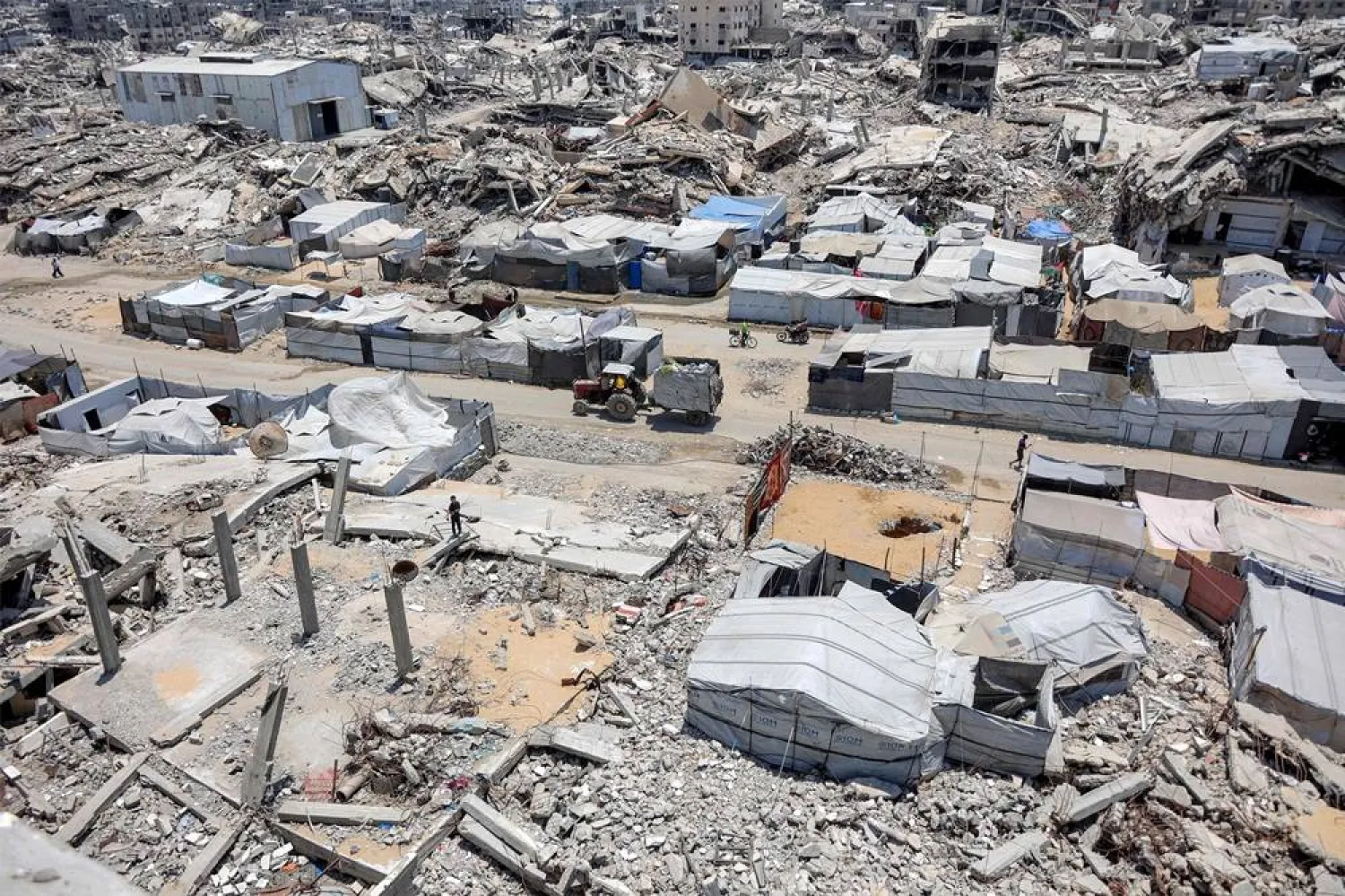 Tents and shelters are pictured next to rubble of collapsed buildings at a camp for people displaced by war in the Sheikh Radwan neighborhood of Gaza City on July 6, 2026. (AFP)