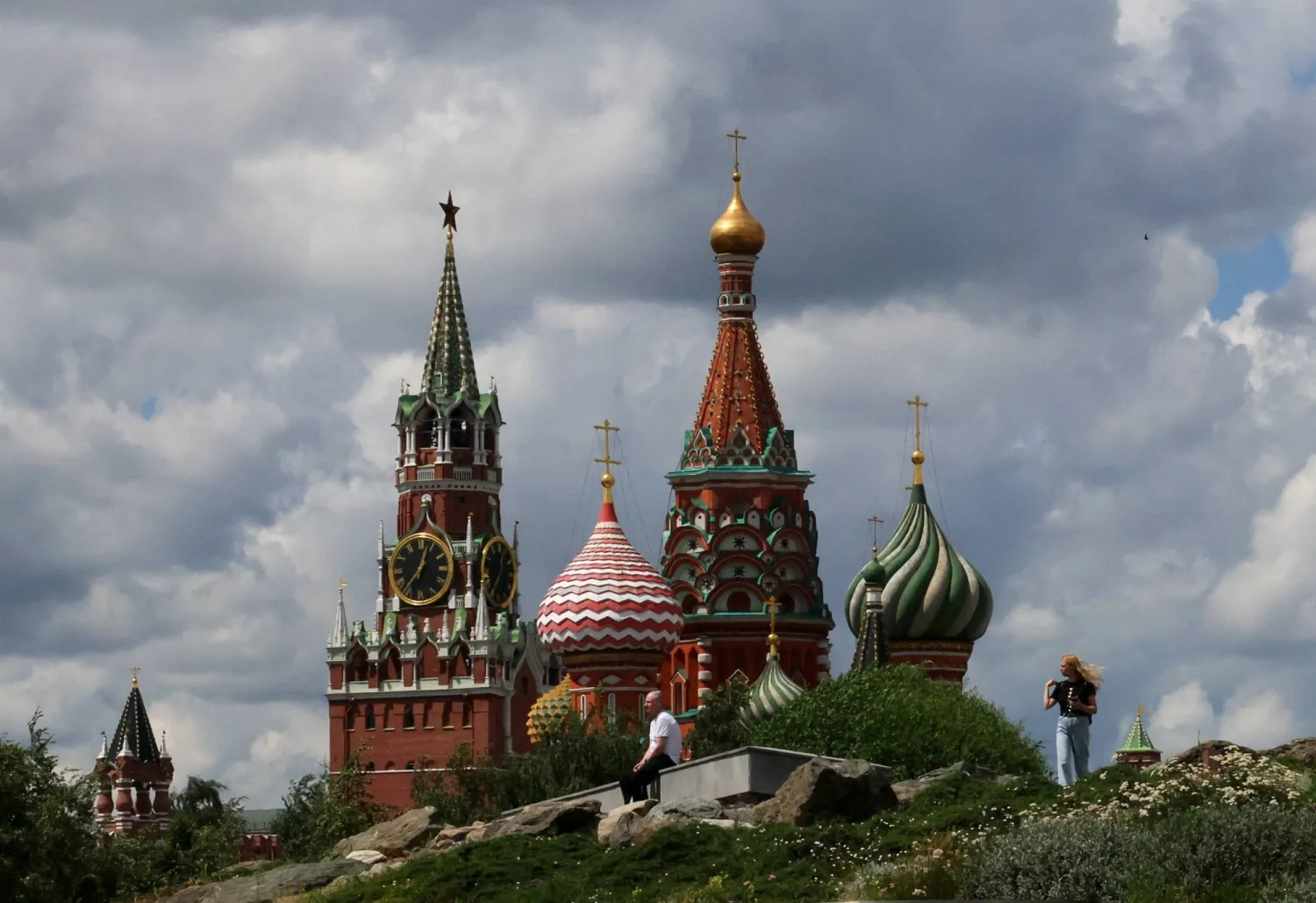 People walk in Zaryadye Park near St. Basil's Cathedral and the Kremlin's Spasskaya Tower in central Moscow, Russia, July 6, 2026. REUTERS/Anastasia Barashkova
