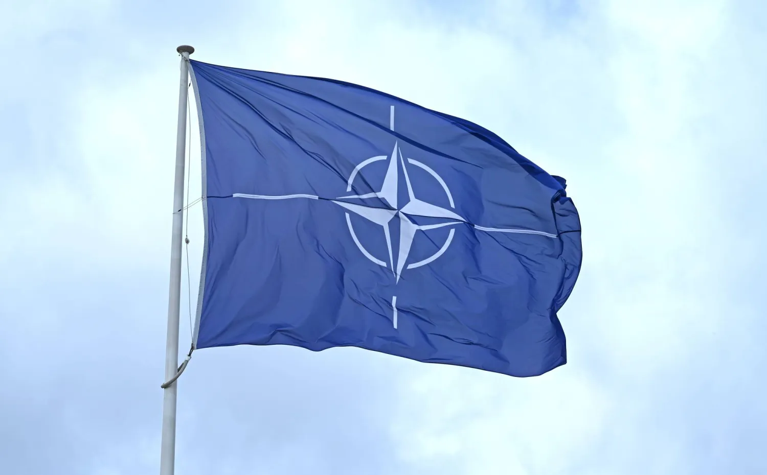 FILED - 19 May 2026, Belgium, Brussels: FILE PHOTO - A flag with the NATO logo flies in the wind in front of the NATO headquarters in Brussels. Photo: Elisa Schu/dpa