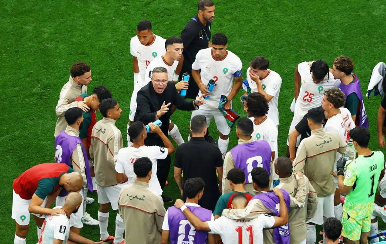 Football - FIFA World Cup 2026 - Round of 16 - Canada v Morocco - Fans gather in Vancouver - Vancouver, Canada - July 4, 2026 Morocco coach Mohamed Ouahbi gives instructions to players during a hydration break. (Reuters)