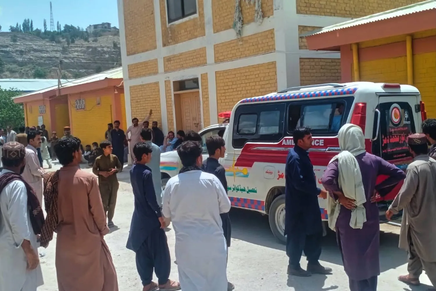 People watch as an ambulance arrive with the bodies of police officers who were killed in an militants overnight attack, at a hospital in Ziarat, a district in Pakistan's southwetern Balochistan province, Tuesday, July 7, 2026. (AP Photo)