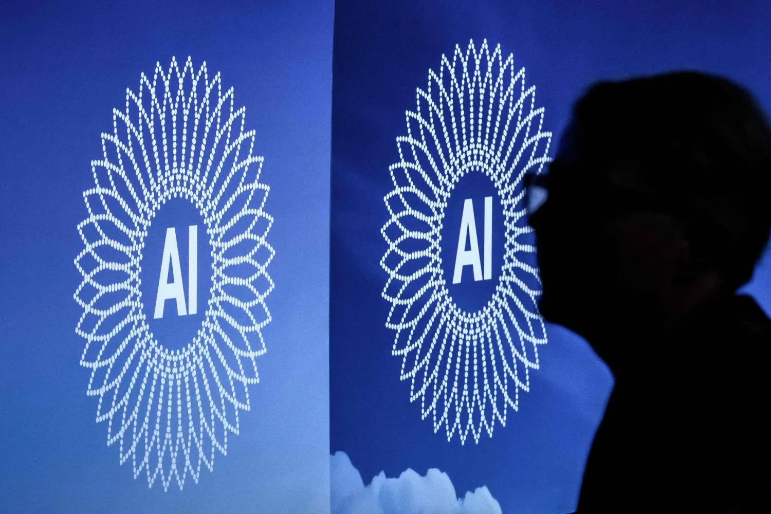 A person is silhouetted next to the logo of the first Global Dialogue on AI Governance, in Geneva on July 6, 2026. (Photo by Fabrice COFFRINI / AFP)