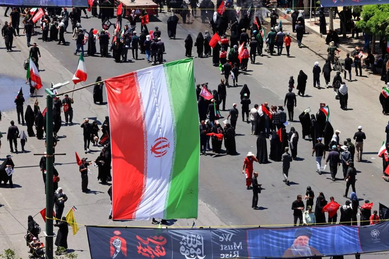 Mourners gather in the street ahead of the funeral of Iran's slain Supreme Leader Ali Khamenei and members of his family at the Shrine of Imam Reza, Iran's most revered place of worship, in Mashhad on July 9, 2026. (AFP)