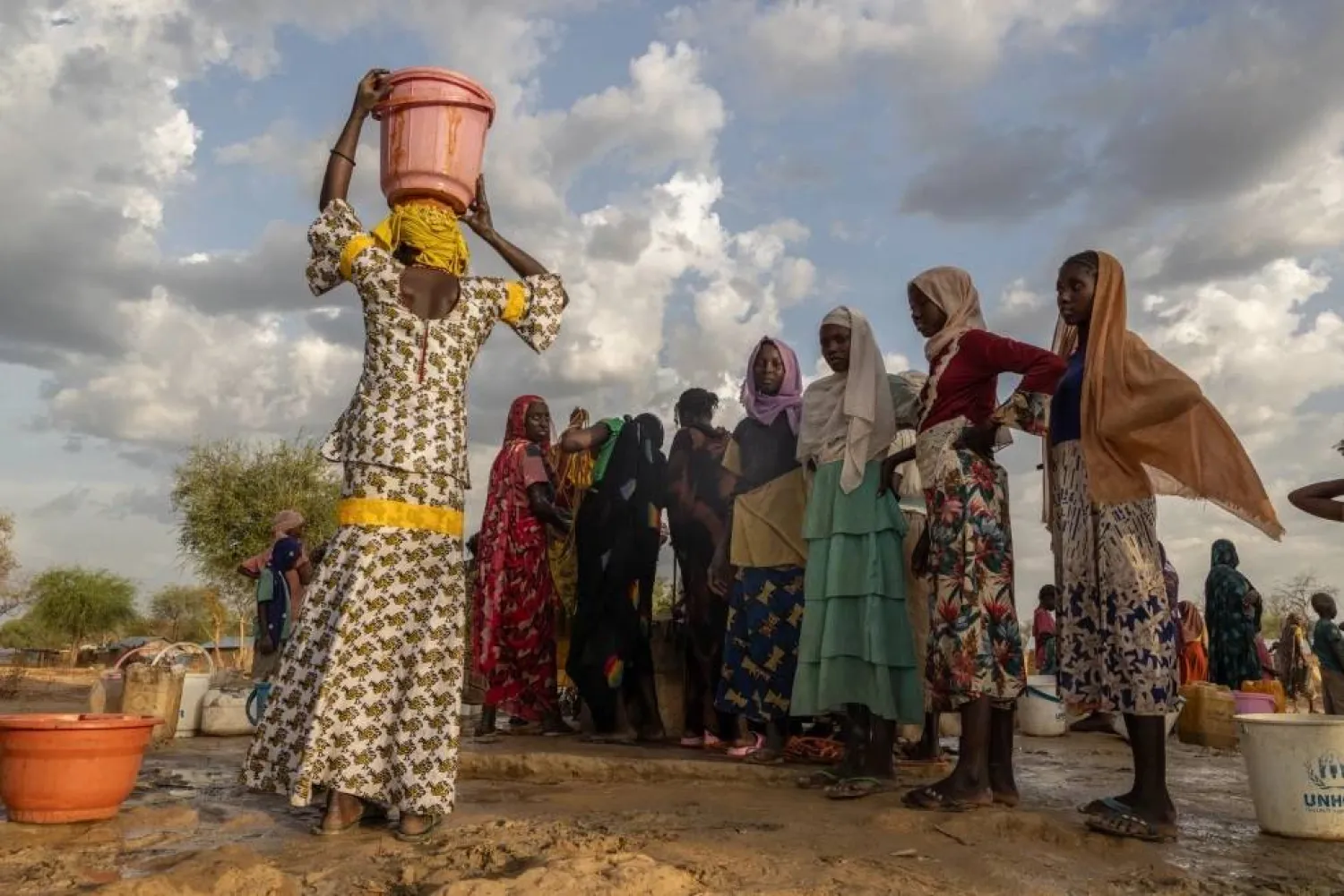FILE -Women and children fetch water at dusk in the Korsi Refugee Camp in Birao, the Central African Republic, March 27, 2026. (AP Photo/Caitlin Kelly, File)

