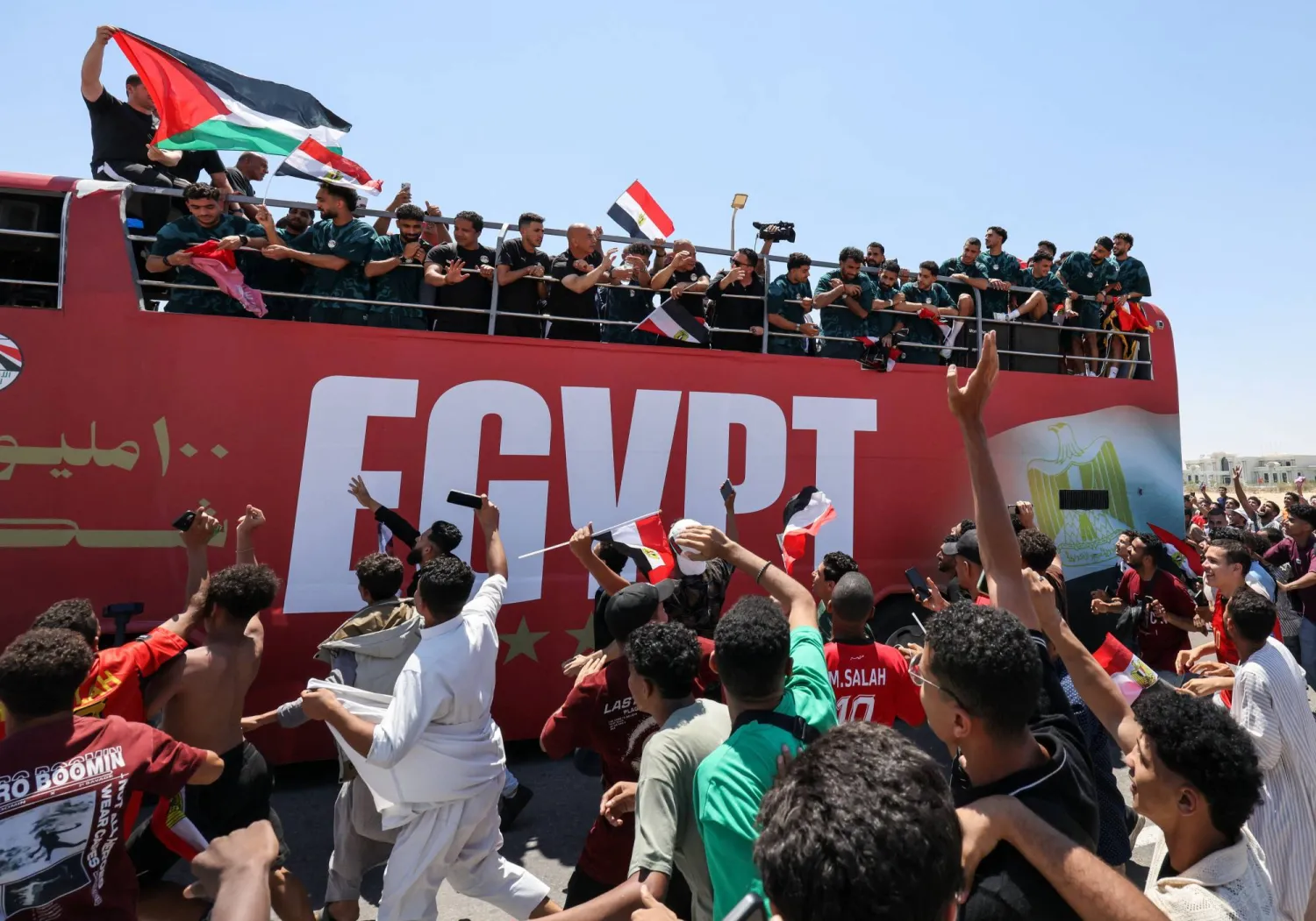 لاعبو منتخب مصر يحيون الجماهير من حافلة مكشوفة (رويترز)