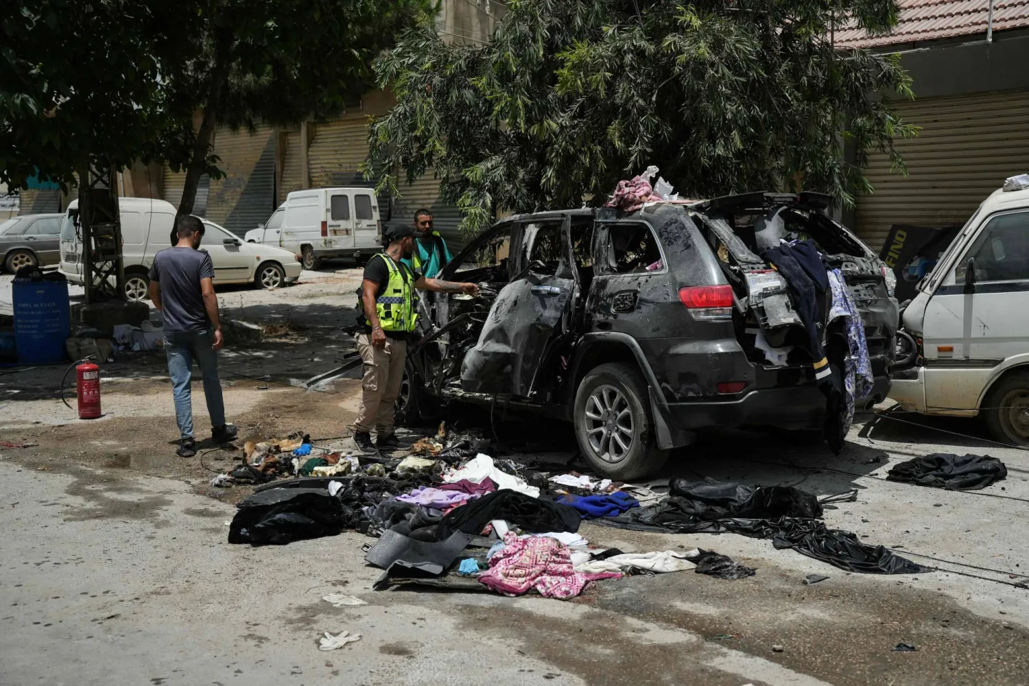 First responders inspect the wreckage of a car reportedly targeted by an Israeli strike in Nabatieh on July 6, 2026. (AFP)