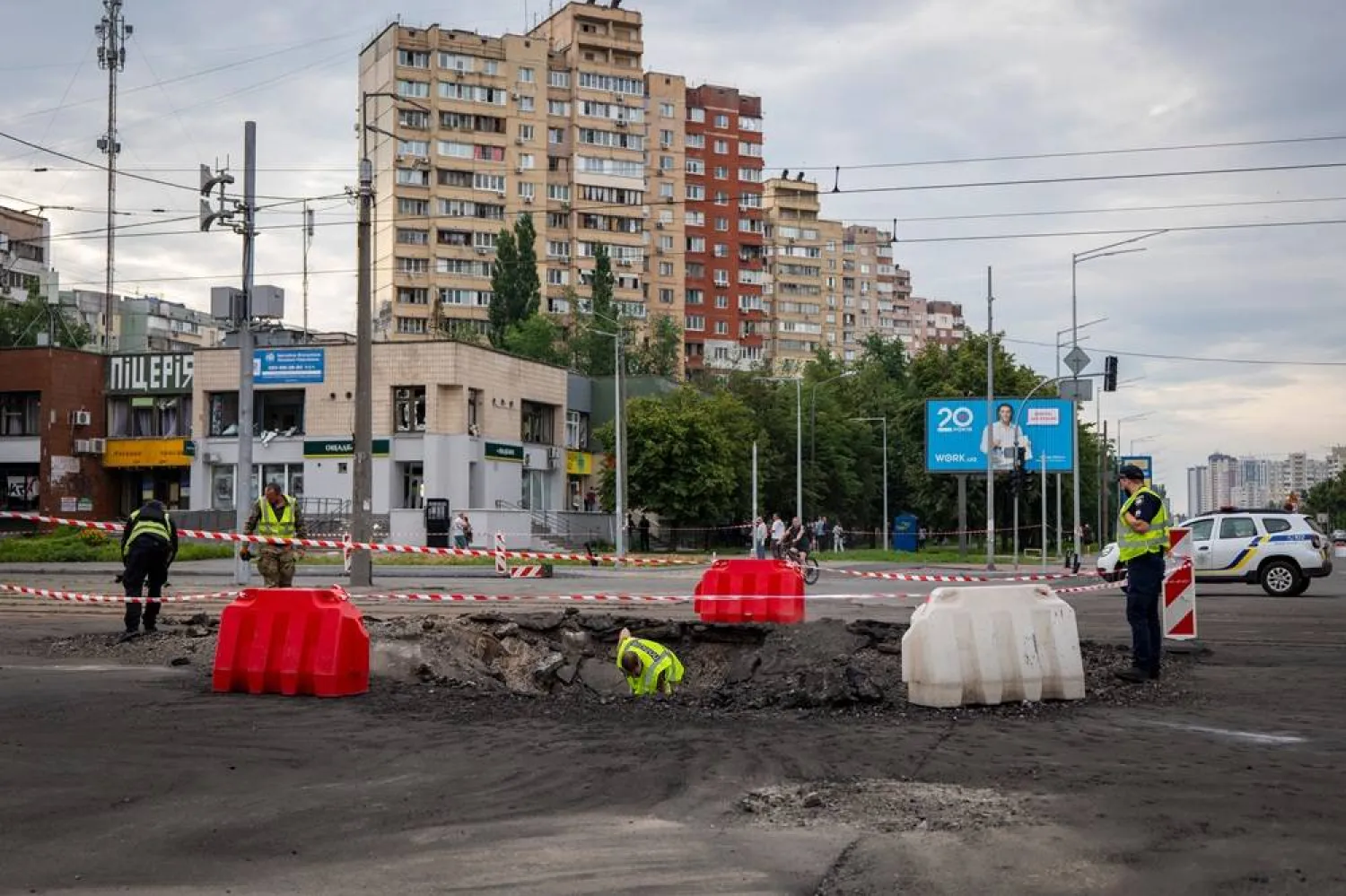 A sapper examines the impact site of a Russian missile in a residential area of Kyiv, Saturday, July 11, 2026. (AP) 