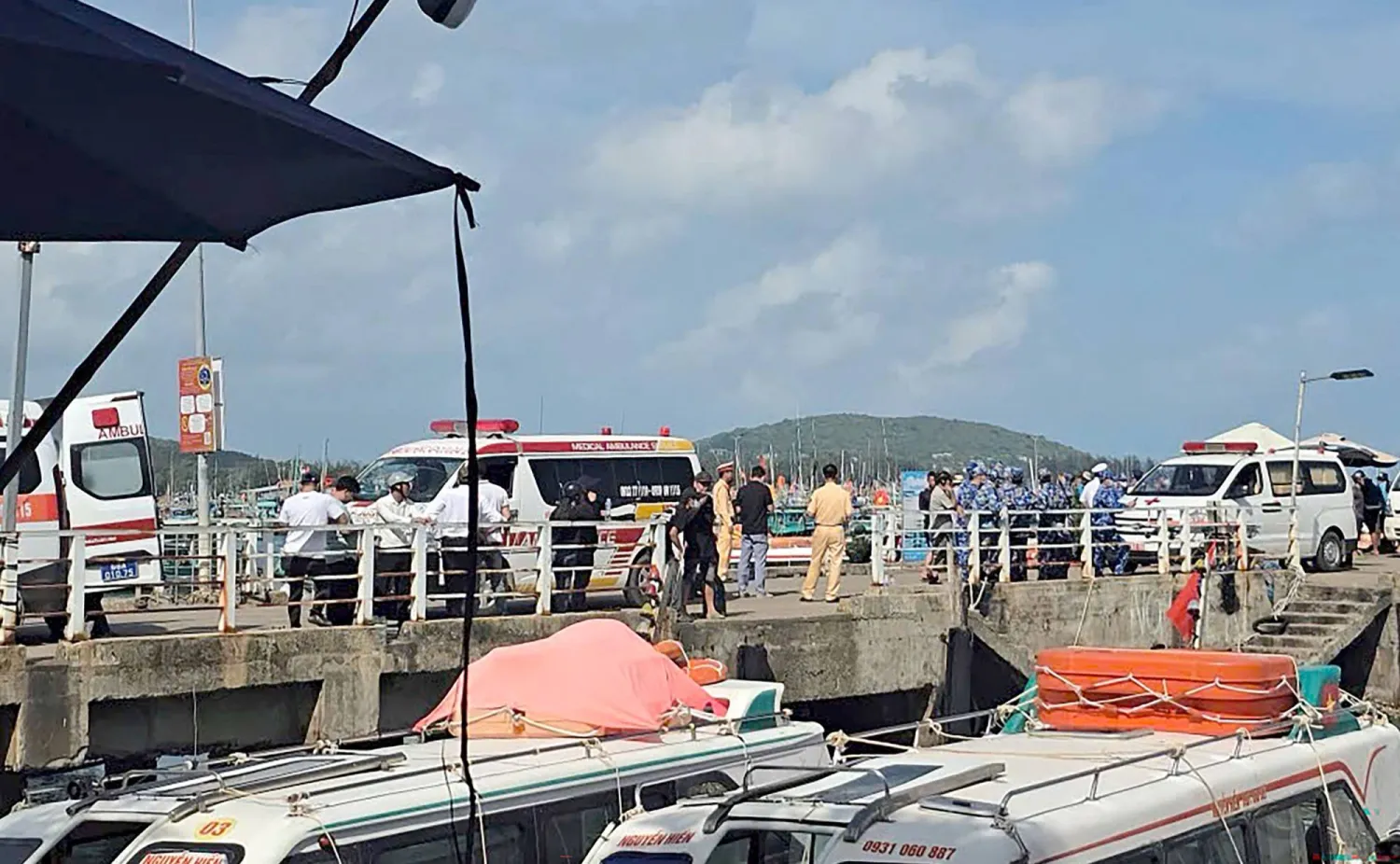 Ambulances line up on a pier to help victims of a boating accident after a tourist vessel capsized off Phu Quoc Island in southern Vietnam's An Giang Province on July 11, 2026. (Photo by AFP)
