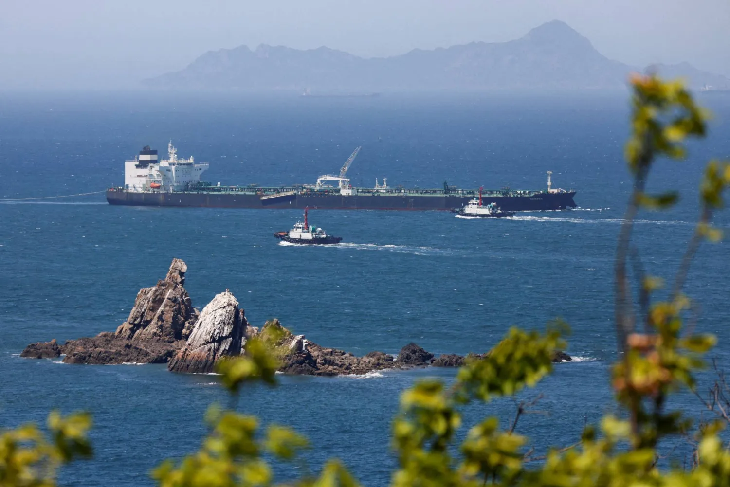  Tugboats guide the crude oil tanker Odessa, carrying UAE crude after passing through the Strait of Hormuz with its Automatic Identification System transponder turned off, navigates the waters at Daesan port, where it is expected to discharge crude oil, in Seosan, South Korea, May 8, 2026. (Reuters)

 