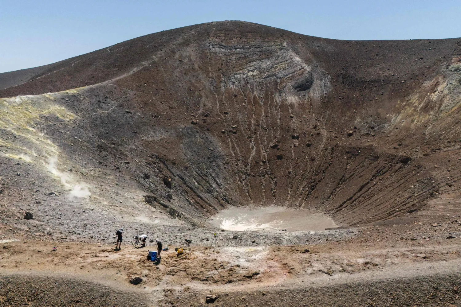 Vulcanologists collect data from gas emissions with a drone and a laser during a mission in the crater of La Fossa, on Vulcano Island, one of the seven islands of the Aeolian Archipelago of Sicily, on July 9, 2026. (Photo by Marco Bertorello / AFP)