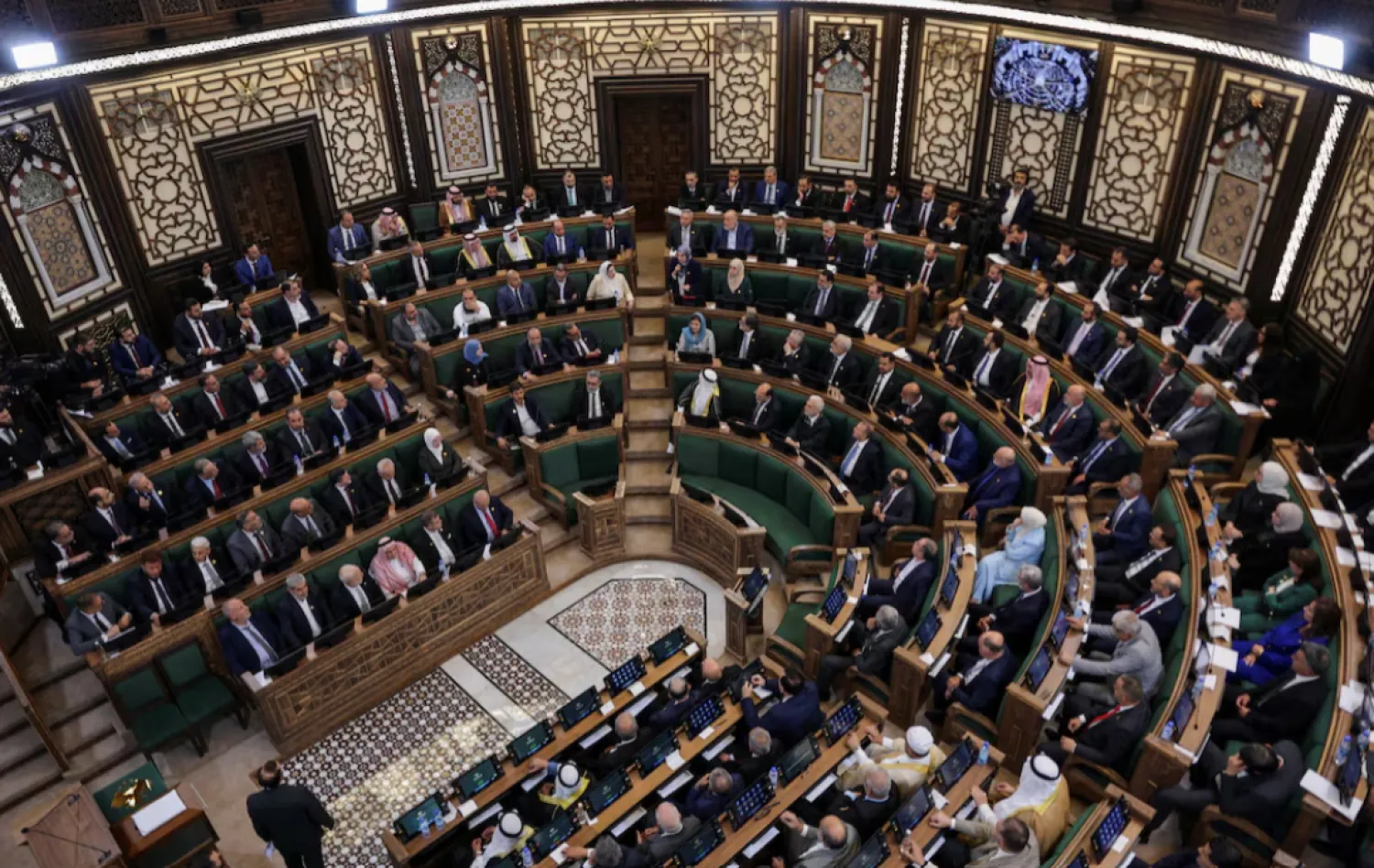  Members of Syria's newly formed People's Assembly attend the body's inaugural session, the first parliament session since the end of the rule of ousted Syrian President Bashar al-Assad, in Damascus, Syria, July 12, 2026. REUTERS/Khalil Ashawi 