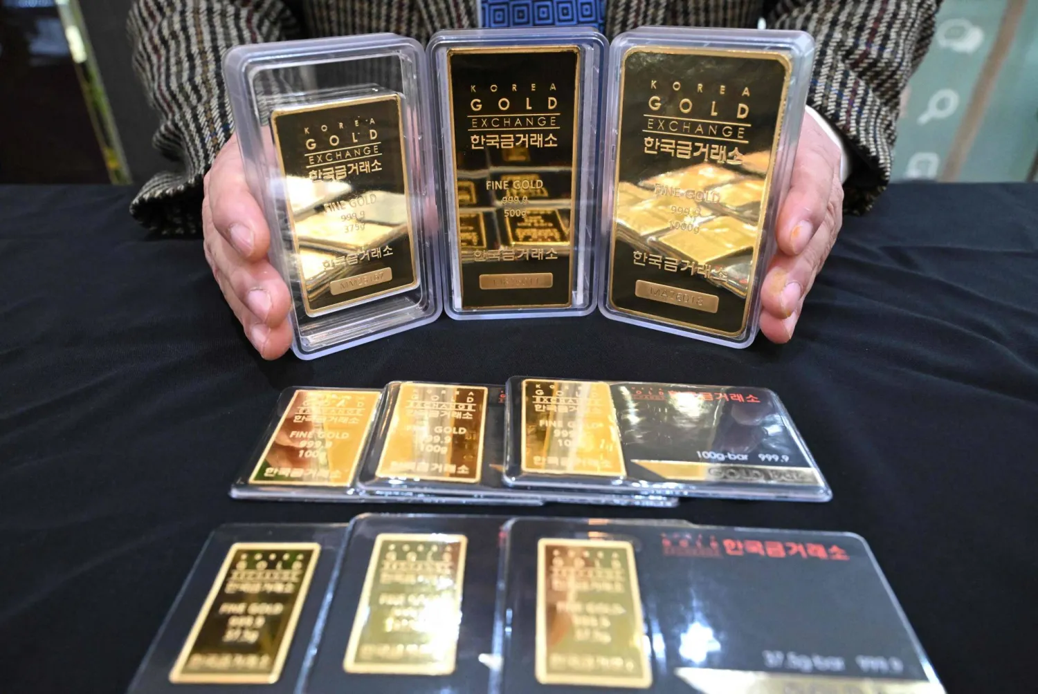 An employee displays gold bars at the Korea Gold Exchange store in Seoul (AFP)