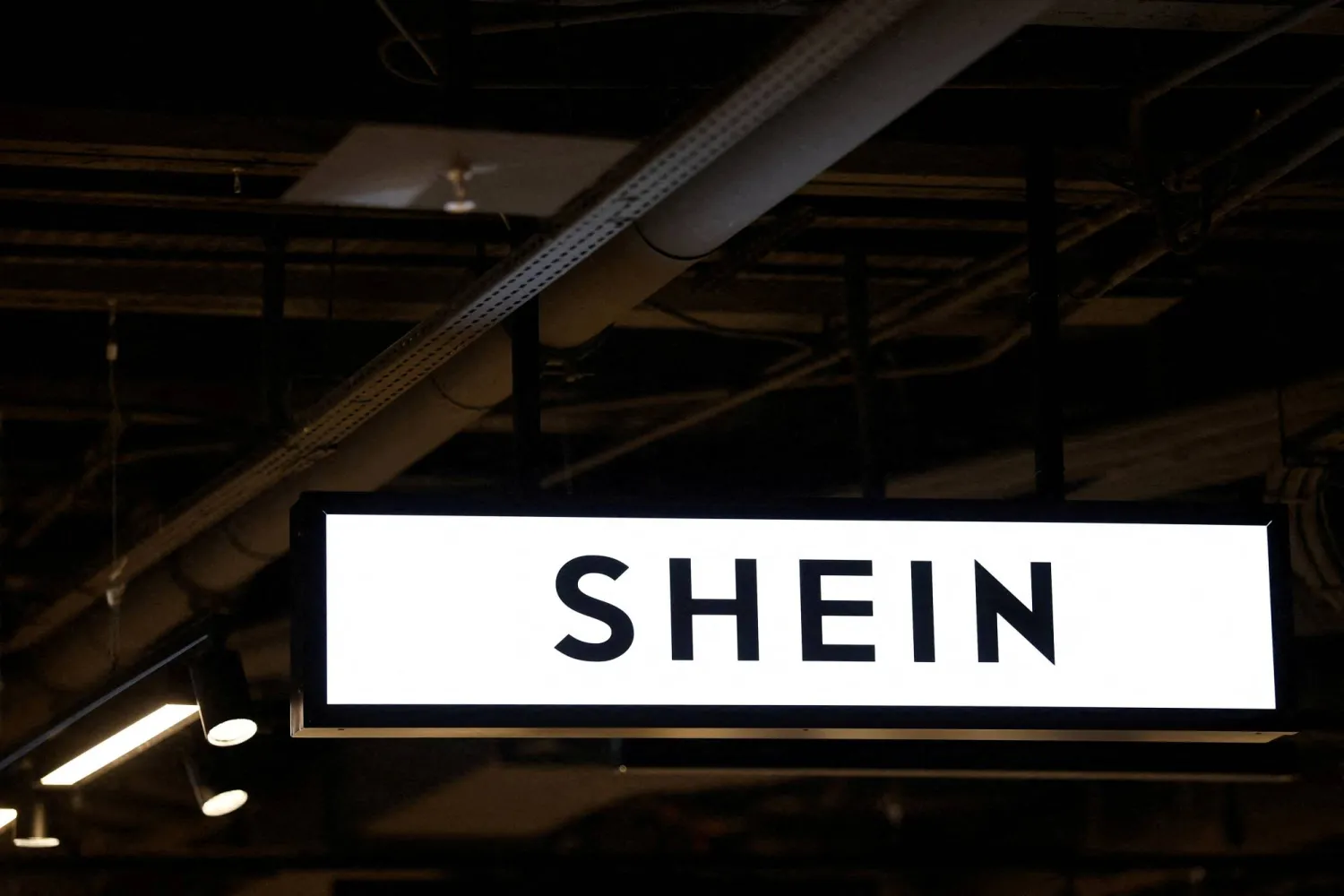FILE PHOTO: A Shein logo is seen at the first physical space of Chinese online fast-fashion retailer Shein on its opening day inside the Le BHV Marais department store, the Bazar de l'Hotel de Ville, in Paris, France, November 5, 2025. REUTERS/Sarah Meyssonnier/File Photo
