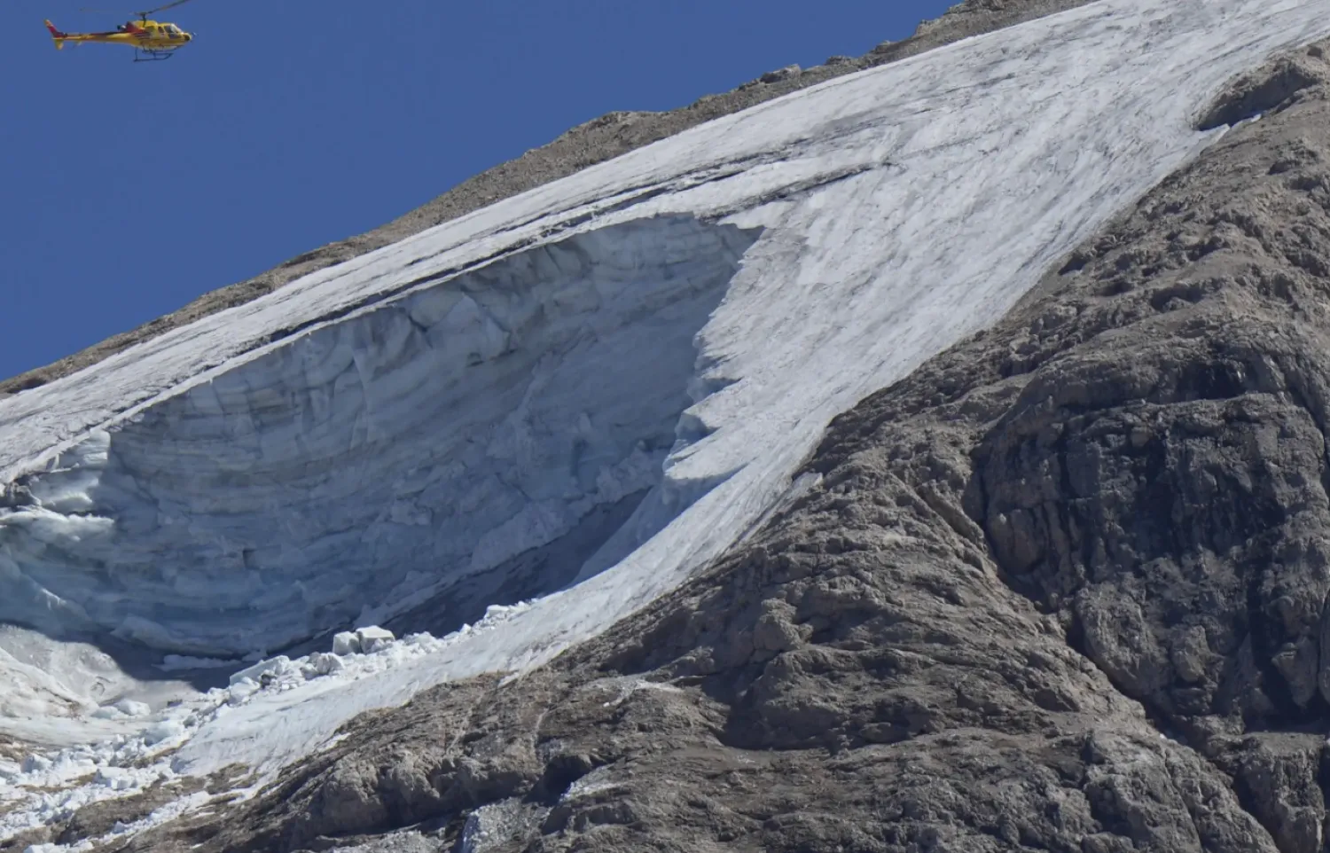 A rescue helicopter hovers over the Punta Rocca glacier near Canazei, in the Italian Alps in northern Italy, July 4, 2022 - File photo/AP news