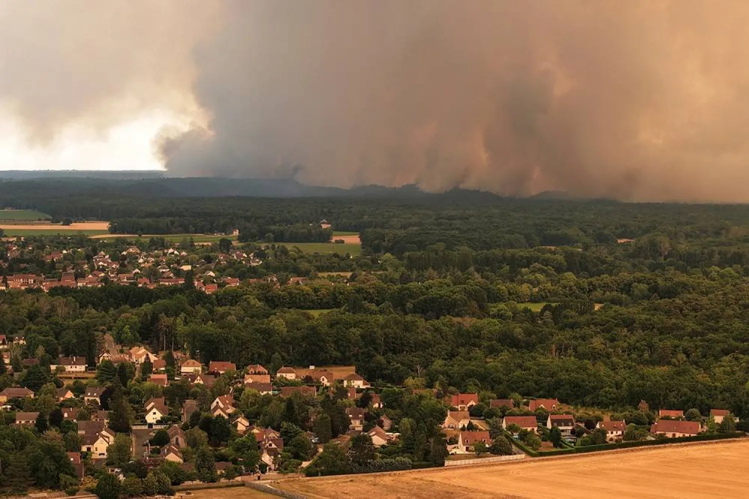  A drone view from Milly-la-Foret shows smoke rising from a wildfire in the Fontainebleau forest near Paris during a heatwave affecting large parts of France, July 13, 2026. (Reuters)