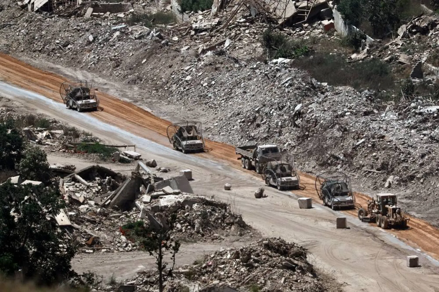  An Israeli military vehicle covered with netting to protect against FPV drones patrols on the Lebanese side of the border, as seen from an undisclosed location along the border, 13 July 2026. (EPA)
