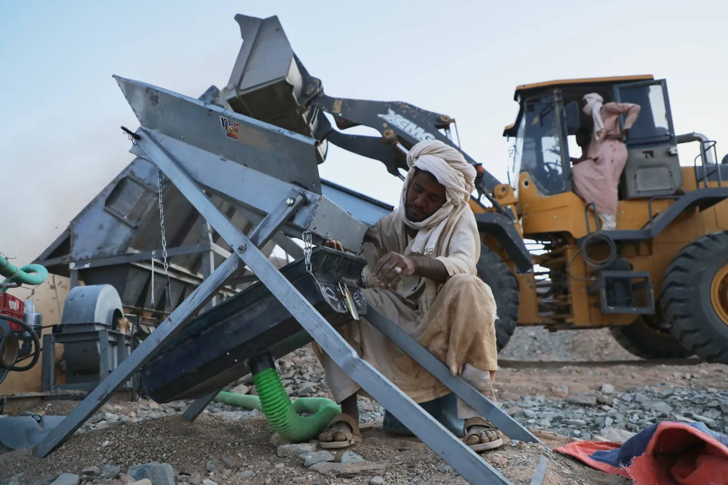 An artisanal miner operates an ore-processing machine used to separate gold-bearing material at a mining site in Dalago Mahas, Sudan’s Northern State, Thursday, May 7, 2026.(AP Photo/Mohnd Blal)