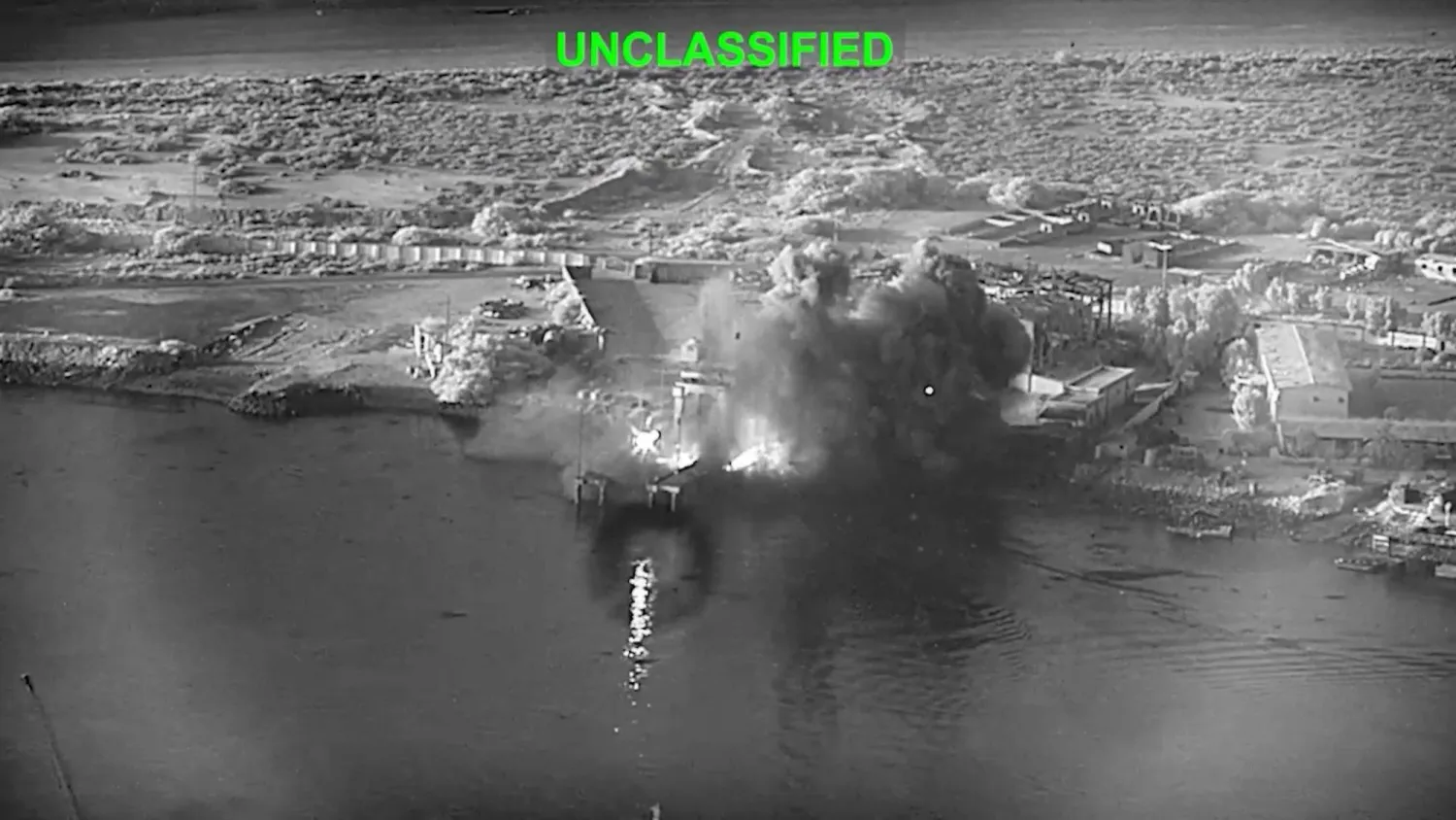  This image from video released by US Central Command, shows an explosion at Bandar Abbas Naval Base, Iran, as three Corsair unmanned surface vessels, also called one-way attack surface drones, fired by the US military, hit the port July 12, 2026. (US Central Command via AP) 